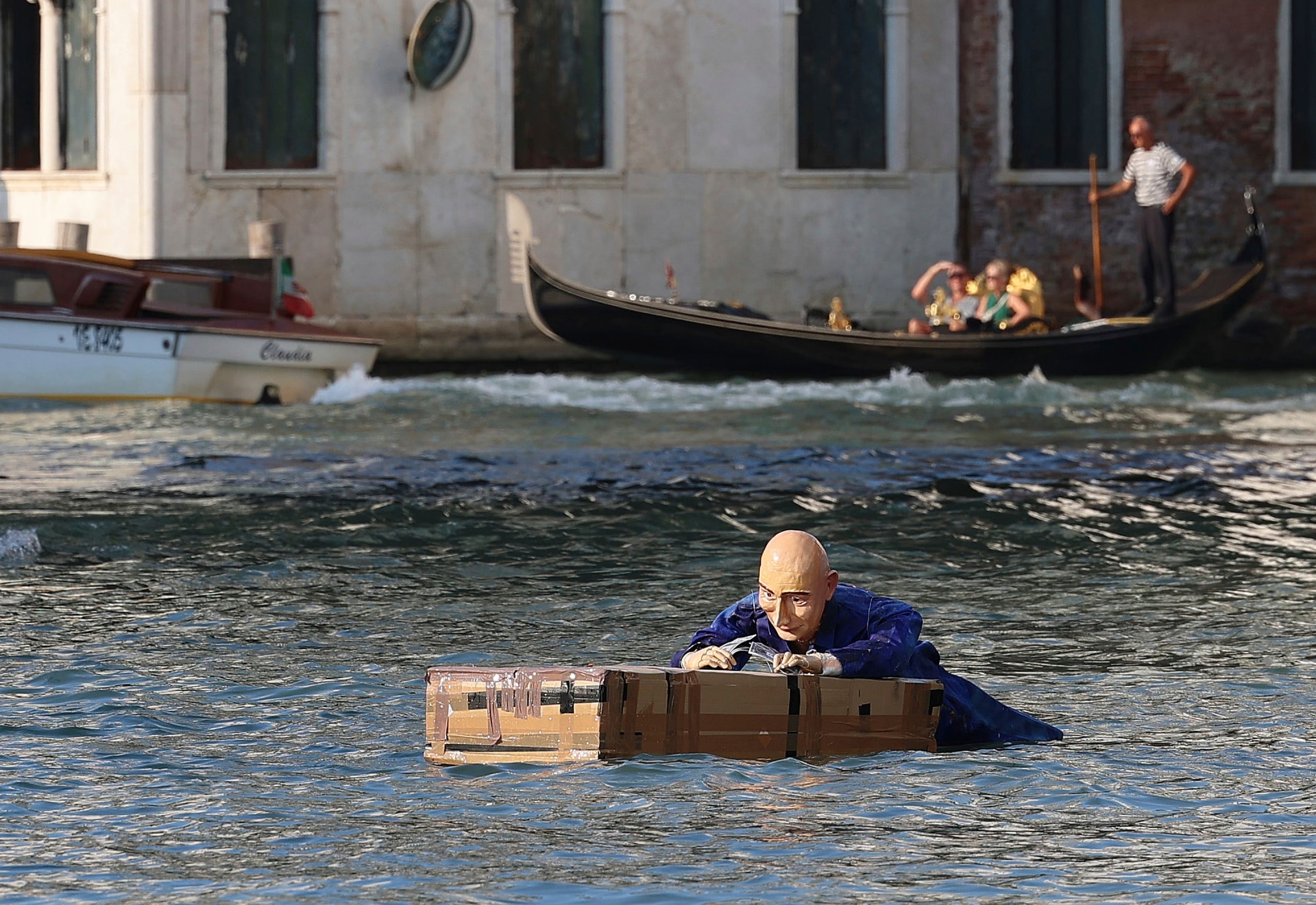 Protests included a mannequin, resembling Jeff Bezos, being floated in a canal in Venice (Click News via AP).