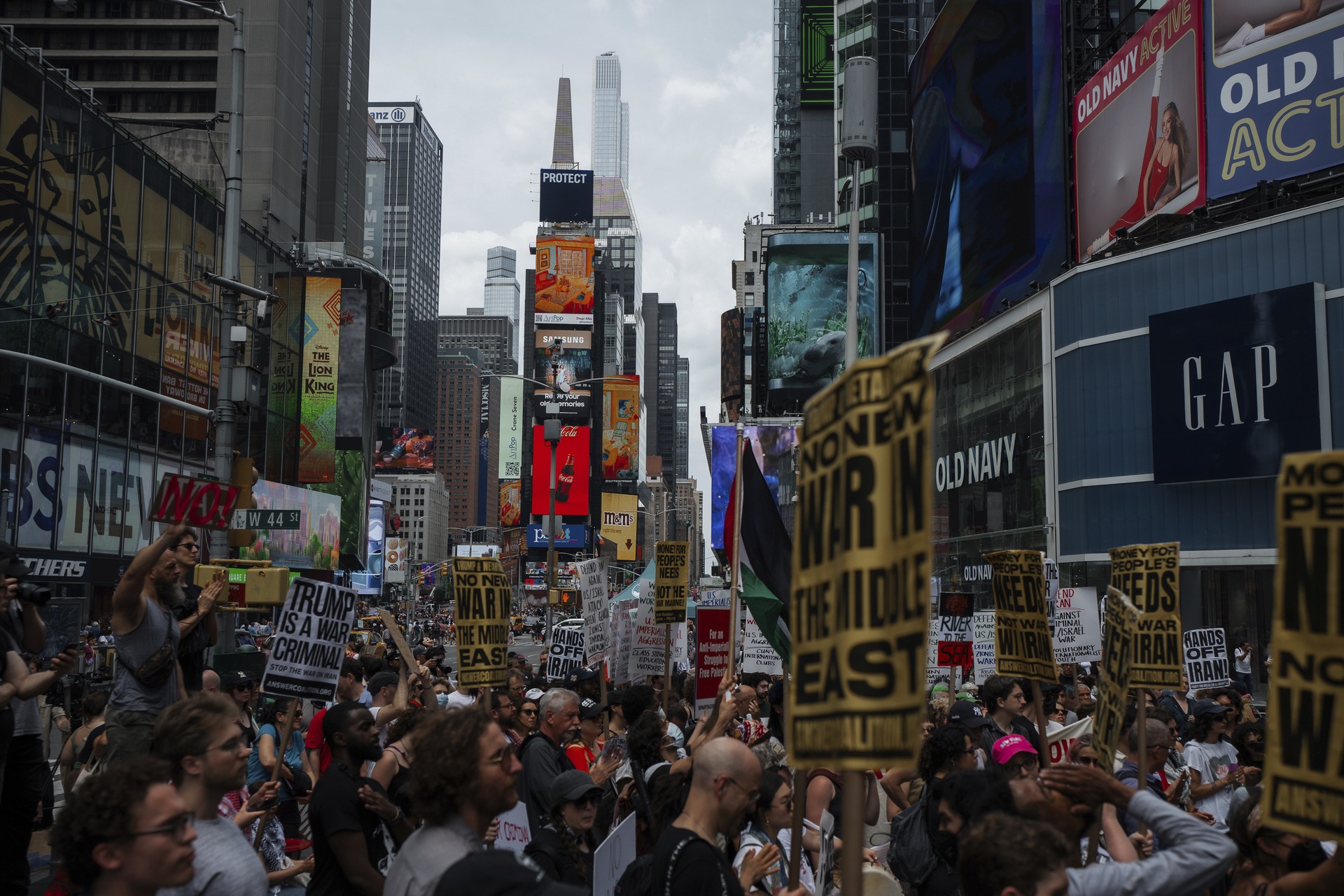 Protesters carry signs during a protest in New York on Sunday against US strikes on Iran (Olga Fedorova/AP).