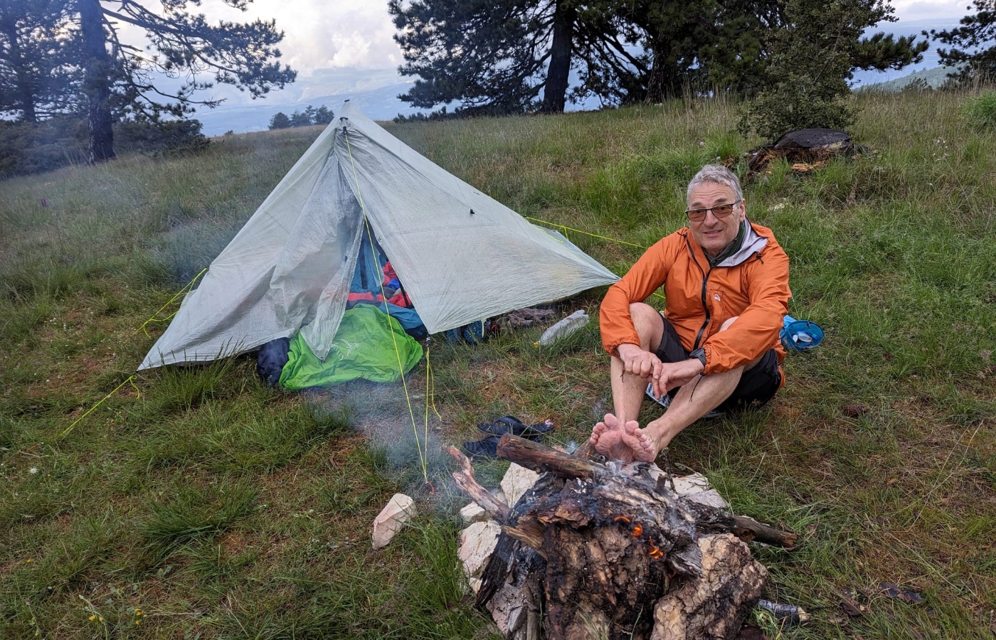 Bernard Trottet wearing an orange jacket walking the Cape Wrath Trail.