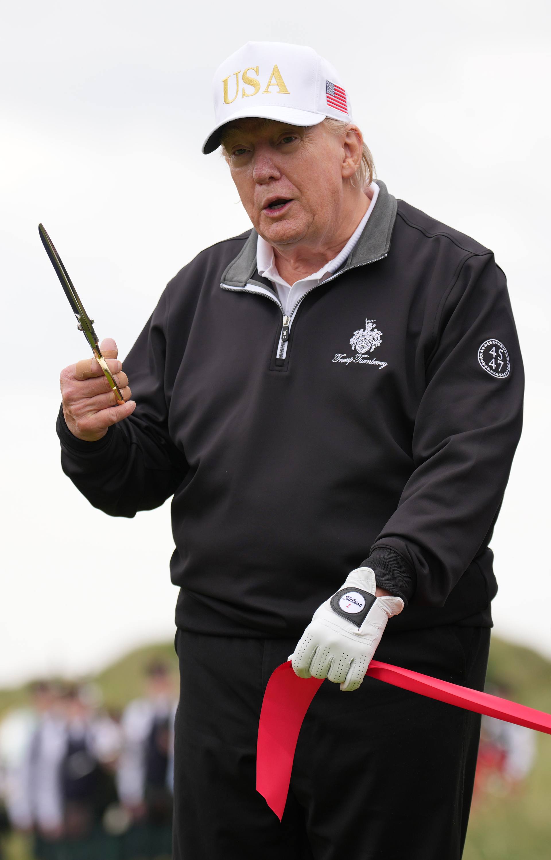 President Donald Trump cuts the ribbon at the ceremony at a new 18-hole course at Trump International Golf Links on July 29.