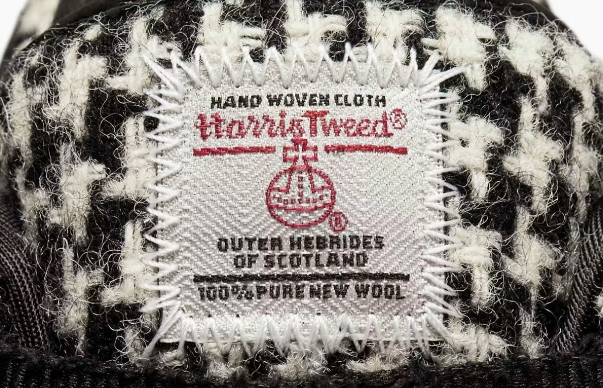The trainers display the official Harris Tweed Orb label, a mark of authenticity and provenance.