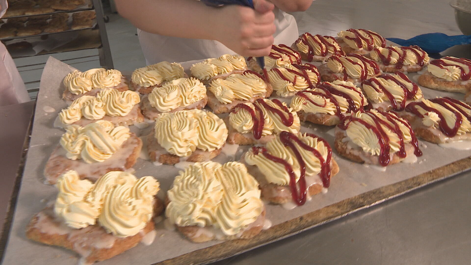 The treat is made with two iced butteries sandwiched with whipped cream and jam