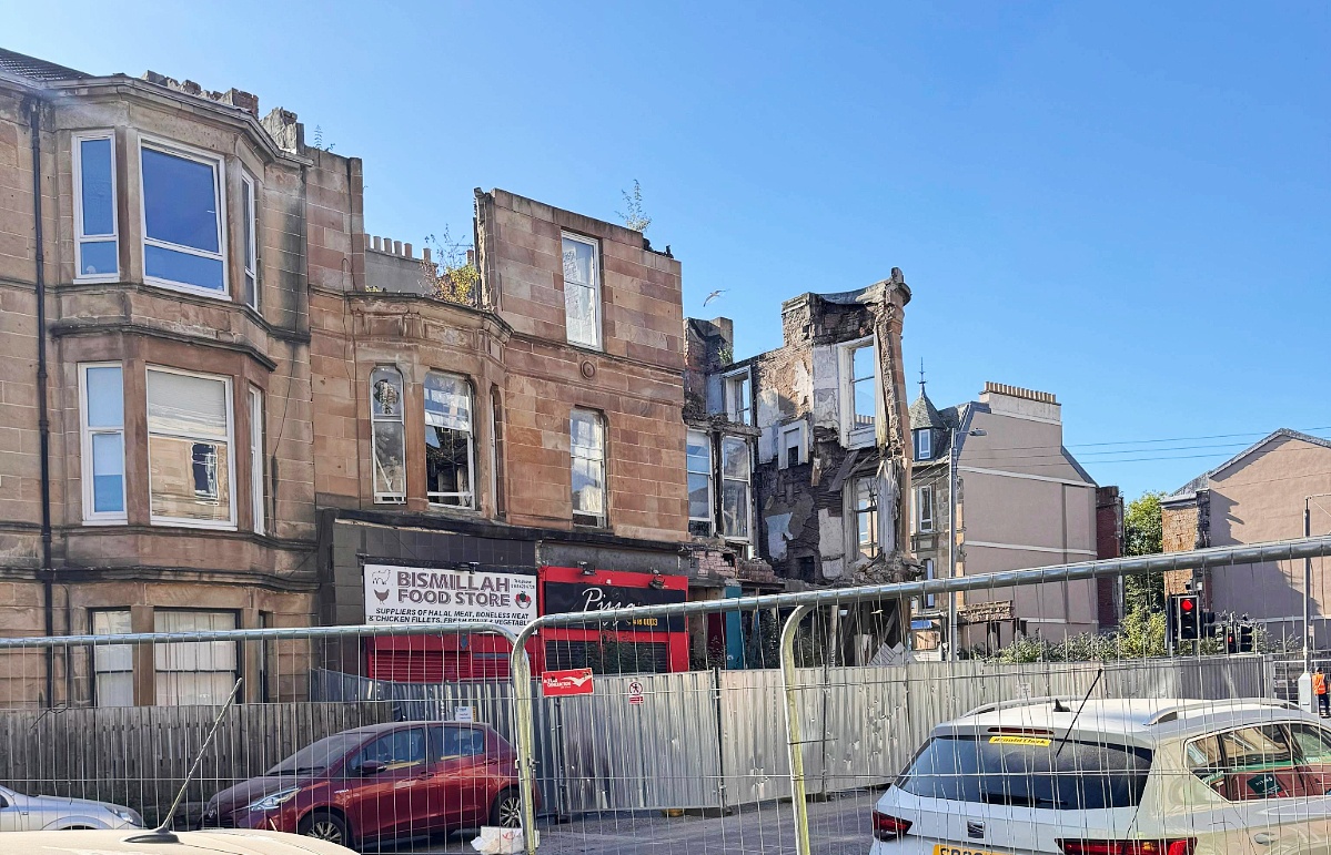Part of the facade of the tenement on the corner of Kenmure Street and Albert Drive has collapsed, five years after the building was gutted by fire.