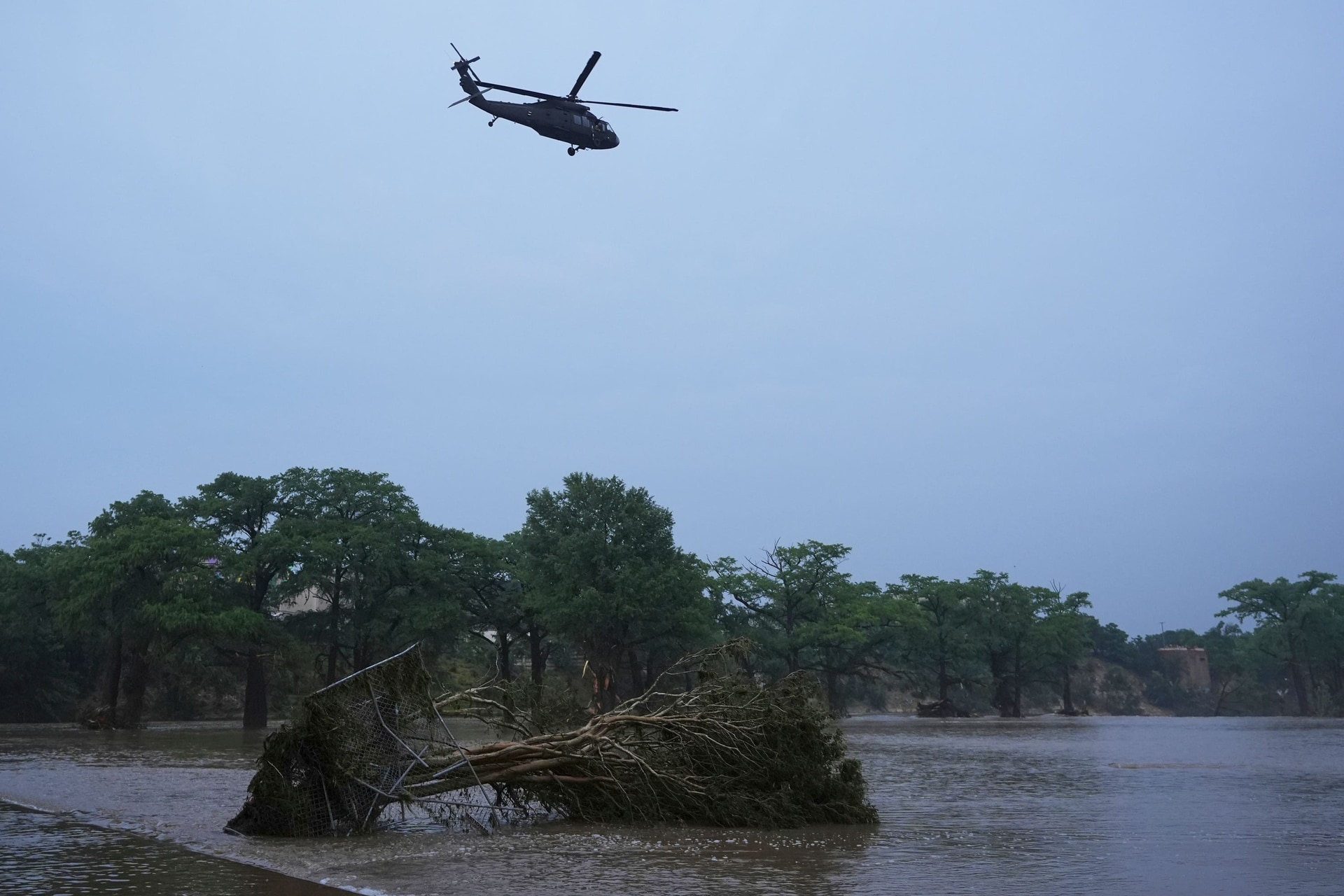 A helicopter flies over the Guadalupe River (Eric Gay/AP)