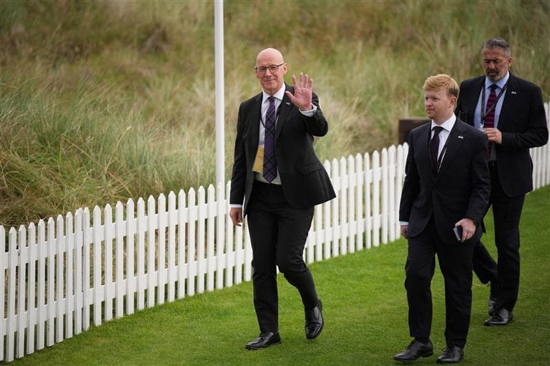 John Swinney, First Minister of Scotland, waves as he arrives for a ribbon-cutting ceremony at a new 18-hole course at Trump International Golf Links.