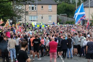 How many asylum seekers are housed in hotels in Scotland?