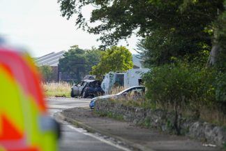 Four taken to hospital after A98 crash involving car and ambulance