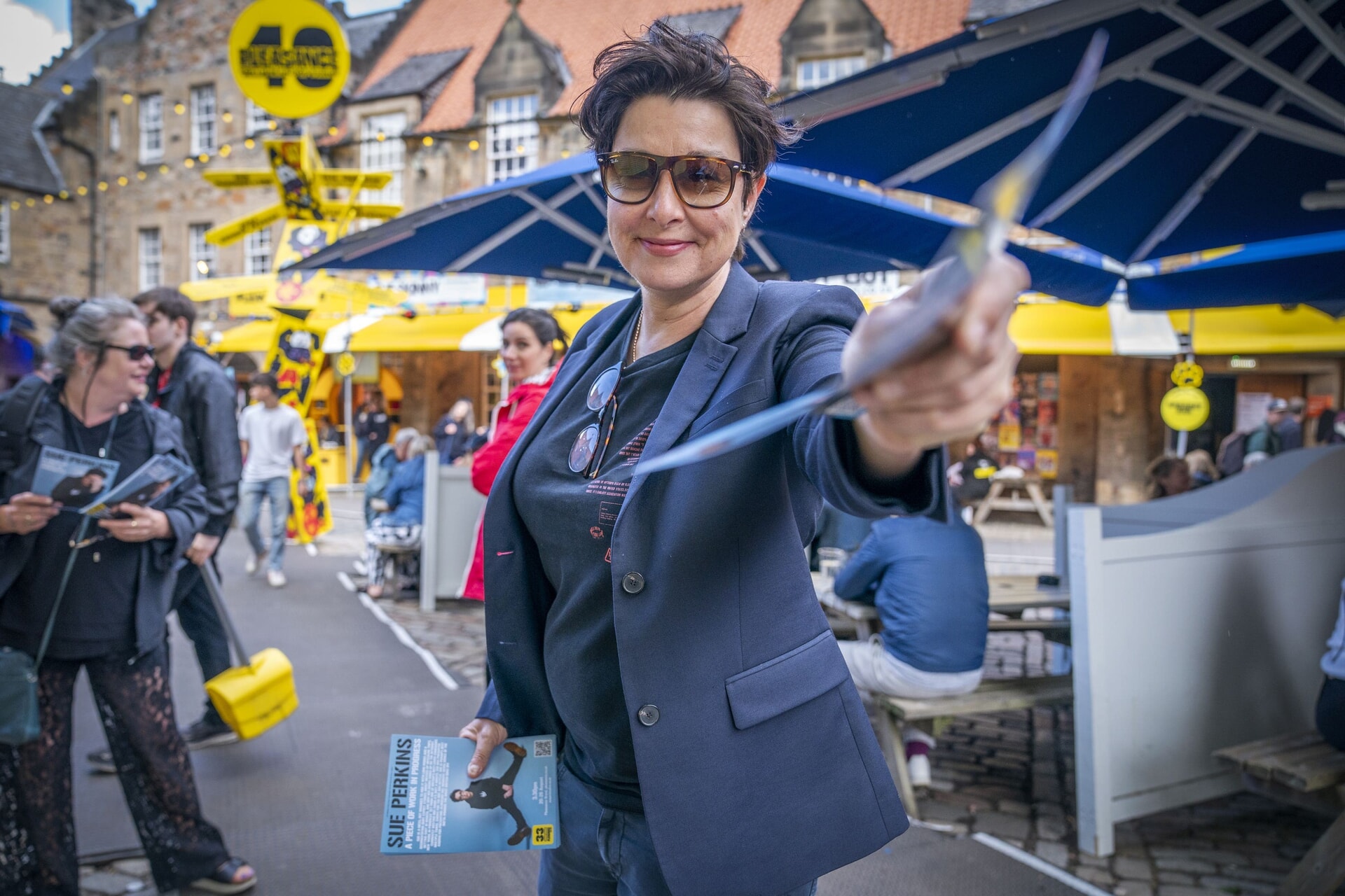 TV presenter and comedian Sue Perkins hands out flyers for her upcoming stand-up show Sue Perkins: A Piece Of Work In Progress outside the Pleasance in Edinburgh.
