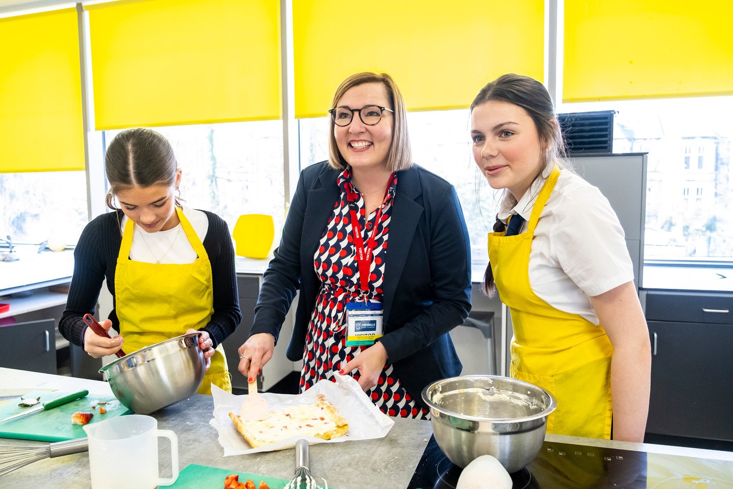 Donna Stewart from the SQA with Practical Cookery pupils at Portobello High School