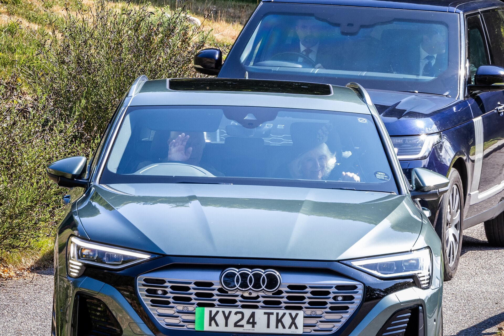 Charles waves as he drives his wife to church on Sunday.