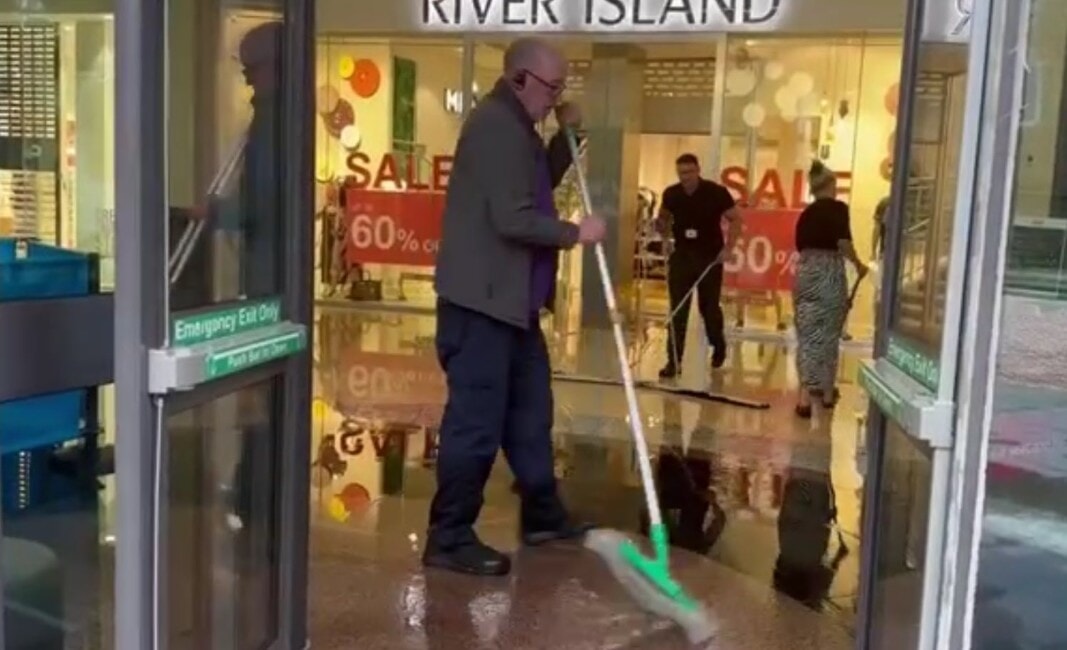 Workers attempt to remove floodwater in Overgate shopping centre