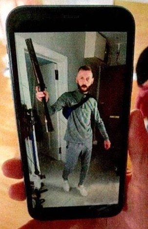 Photos of Gary Strachen armed with the shotgun that he had held to a woman's head helped convict him of assault and possession of a firearm.