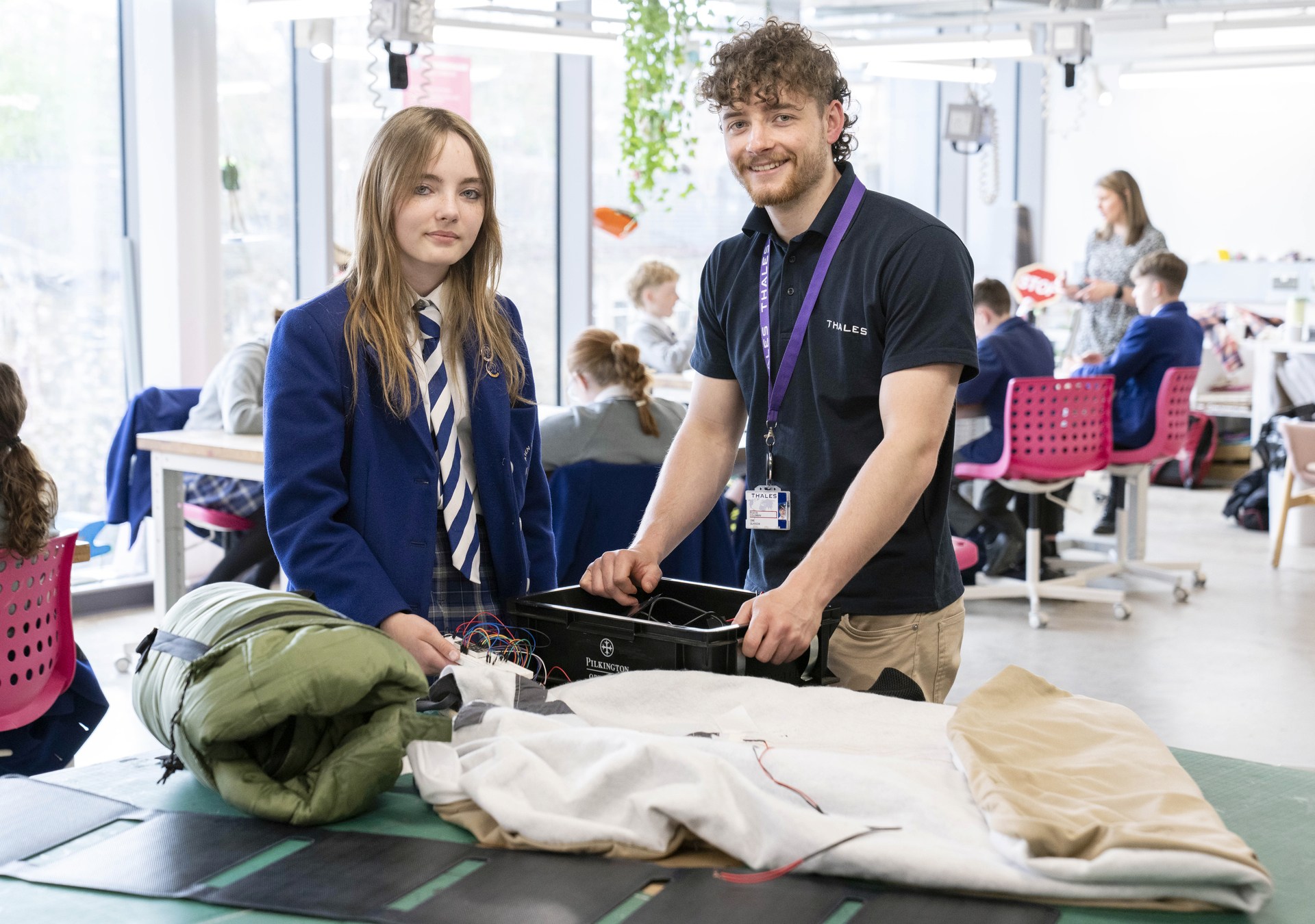 Rebecca Young with a Thales Engineer and the solar powered blanket prototype.