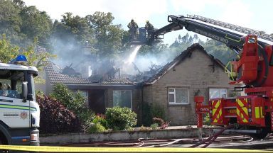 Moray homes evacuated and residents urged to close windows after fire engulfs house