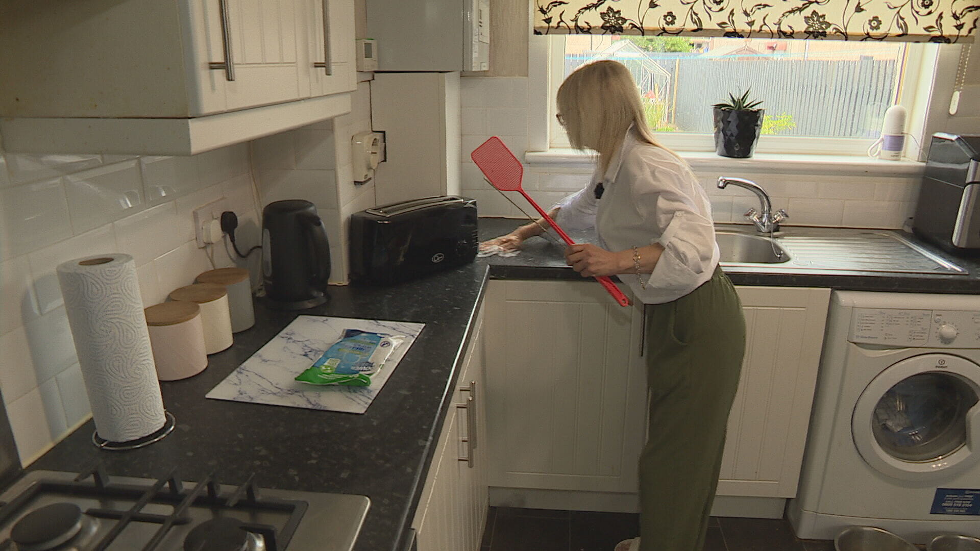 Linda wiping down her kitchen worktop.