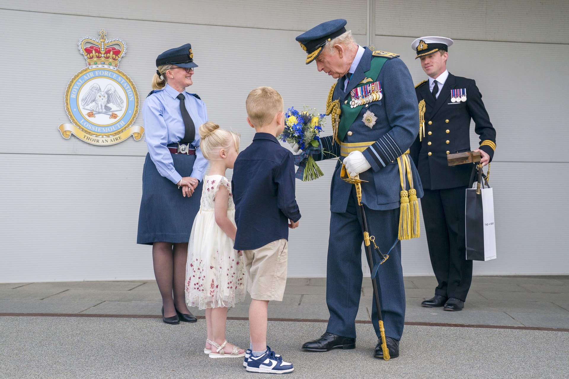 Charles is presented with flowers during his visit to RAF Lossiemouth