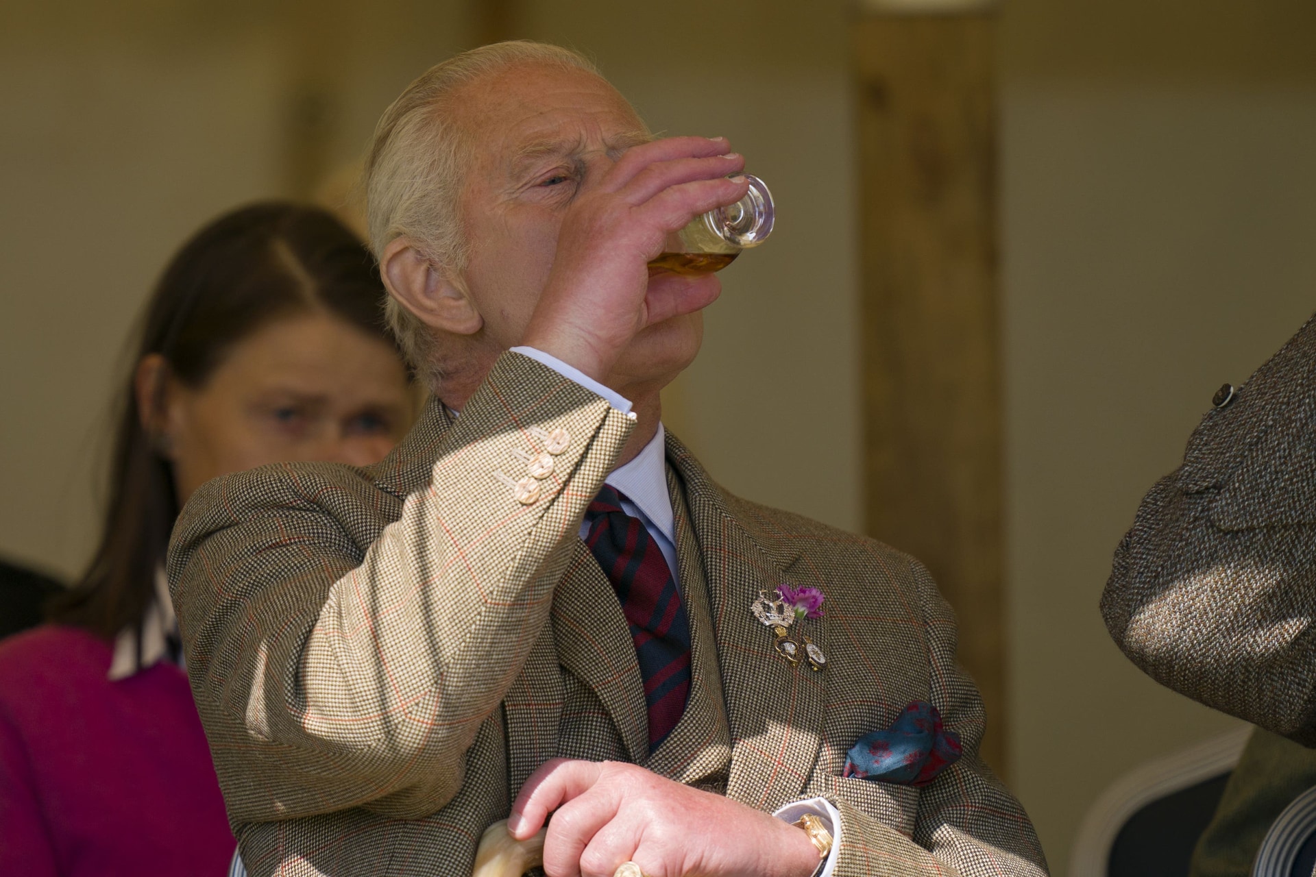 The King drinks a dram of whisky as he watches the Mey Highland Games at the John O’Groats Showground in Caithness