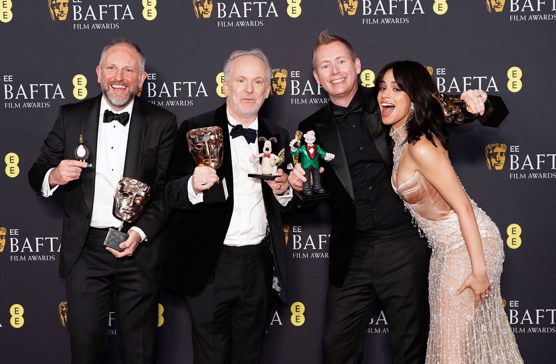 Camila Cabello presents Nick Park, Merlin Crossingham and Richard Beek with the Best Children’s & Family Film award for Wallace & Gromit: Vengeance Most Fowl in the press room during the 78th British Academy Film Awards, at the Royal Festival Hall, Southbank Centre, London (Ian West/PA).