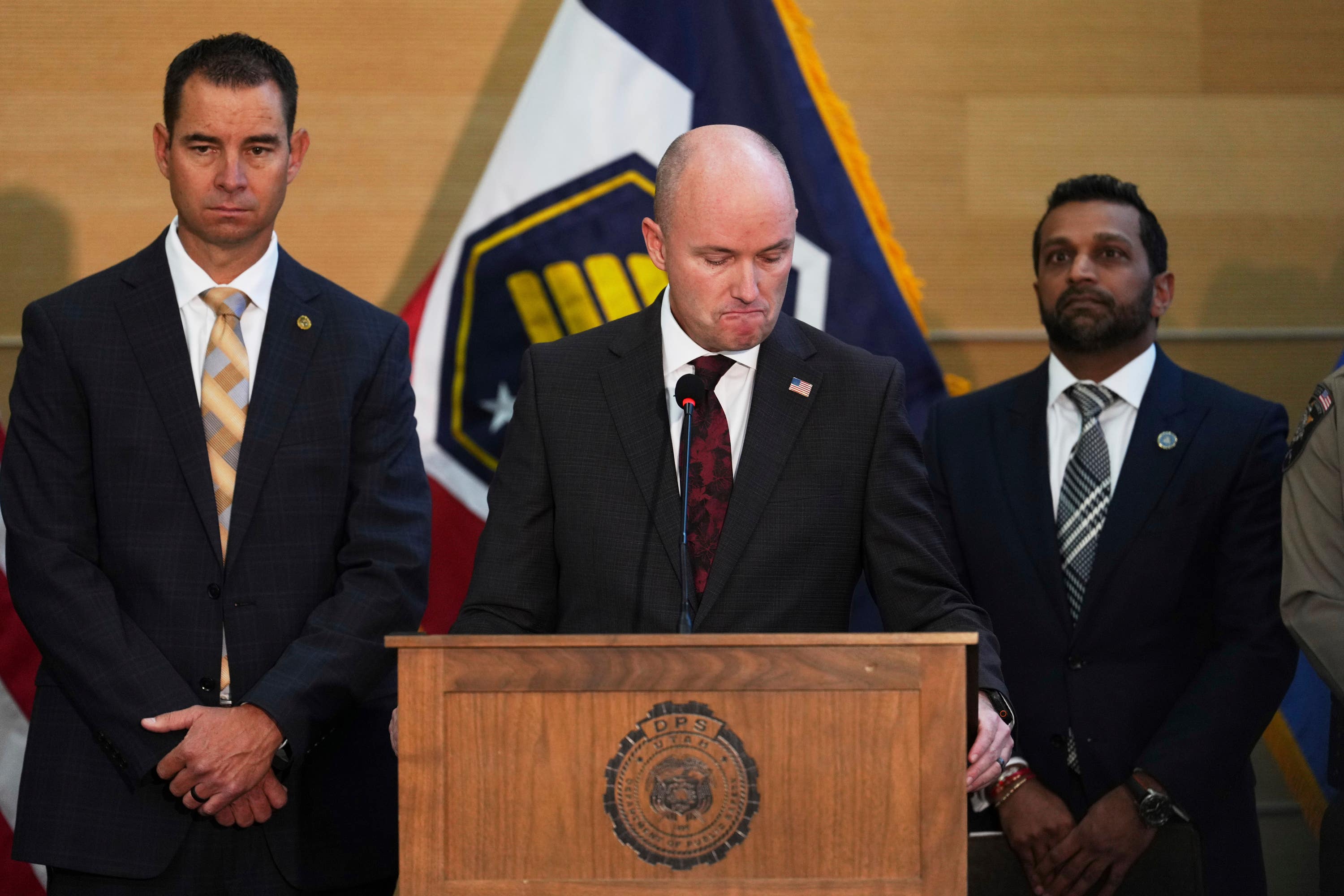 Utah Governor Spencer Cox, centre, and FBI director Kash Patel, right, during a press conference at Utah Valley University on Friday.