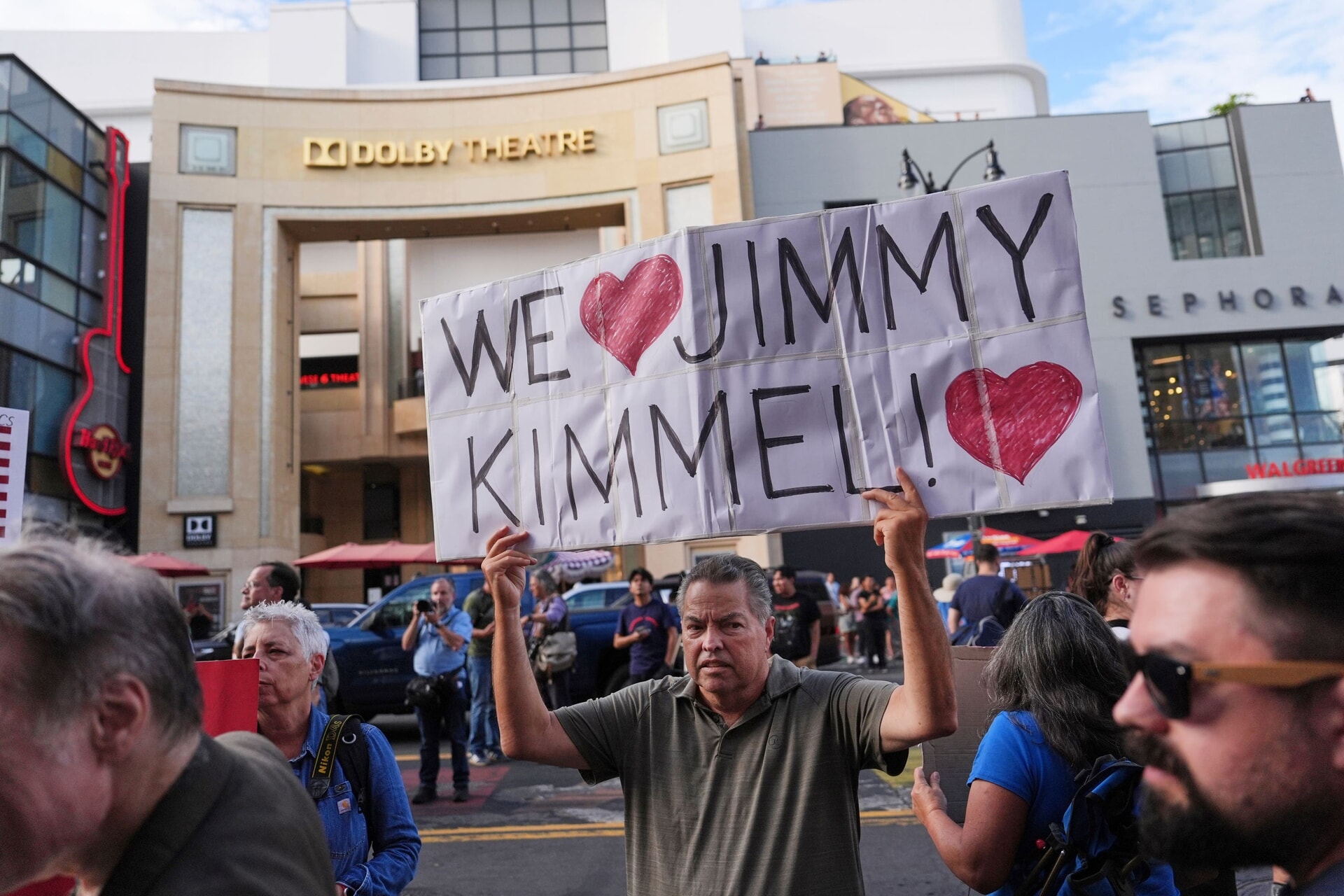 A demonstrator holds a sign outside El Capitan Entertainment Centre, where the late-night show Jimmy Kimmel Live! is staged.