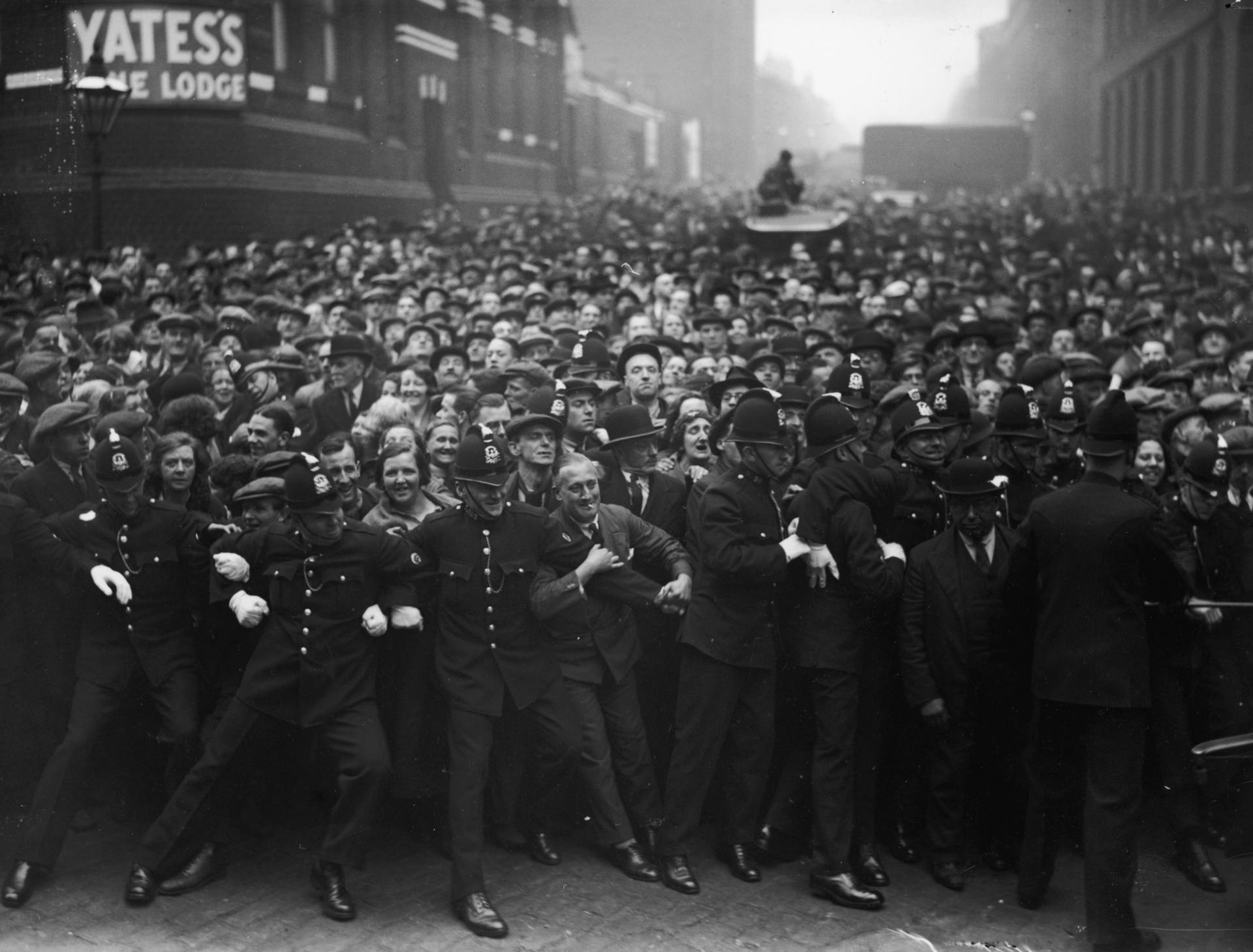 Police hold back a crowd of sightseers outside Strangeways gaol in Manchester before the execution of Dr Buck Ruxton for the murder of his wife and her maid.