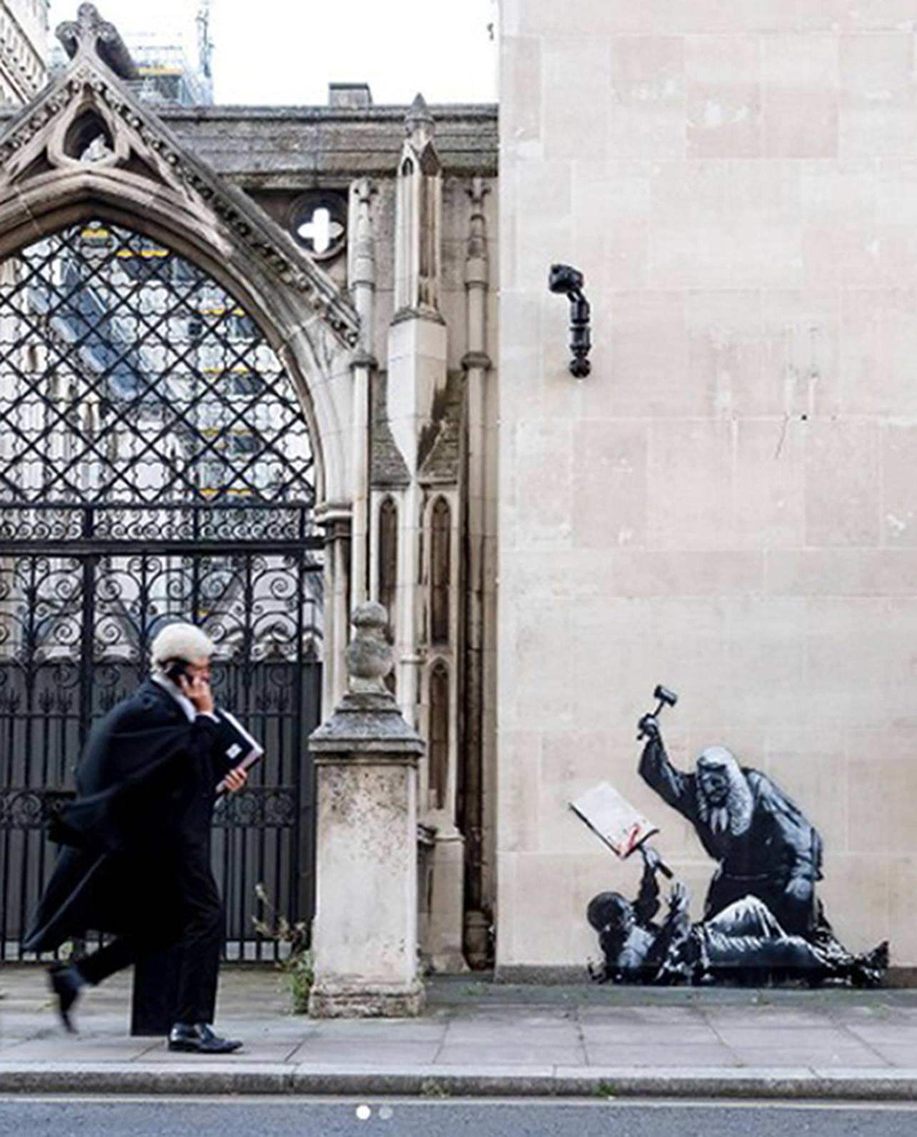Undated handout photo taken from the instagram account of Banksy of the new artwork by the artist which shows a judge attacking a protester with a gavel at the Royal Courts of Justice in London which has already been covered up. The artwork, which is on an external wall of the Queen's Building, part of the Royal Courts of Justice complex, has been concealed by large sheets of black plastic and two metal barriers. Issue date: Monday September 8, 2025.
