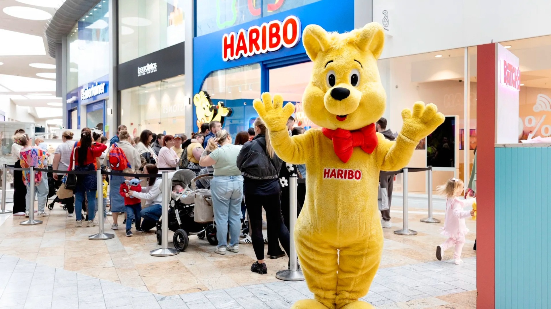 Hundreds of shoppers wait in line as first Scottish Haribo store opens.