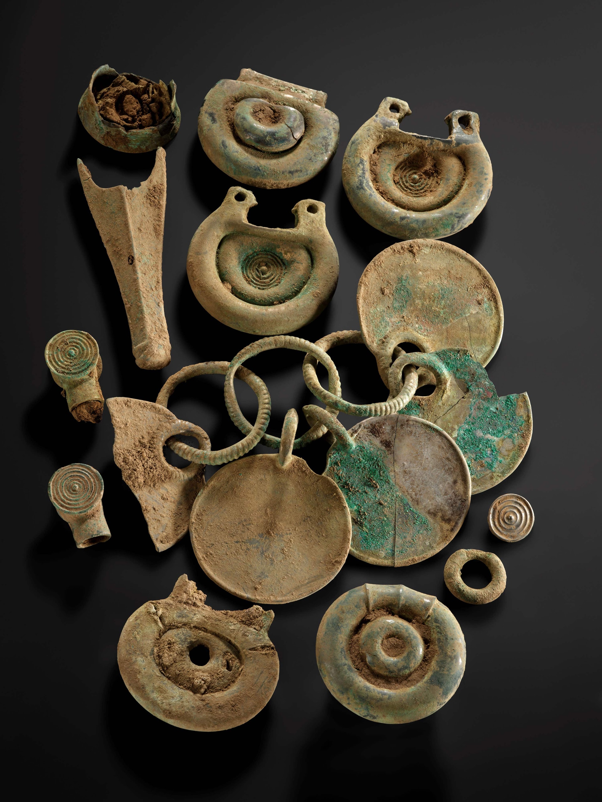 The bronze objects emerged covered in dirt and corrosion (National Museums Scotland/PA).