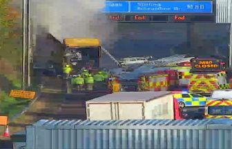 Lorry engulfed by fire on M80 causes M8 traffic jam