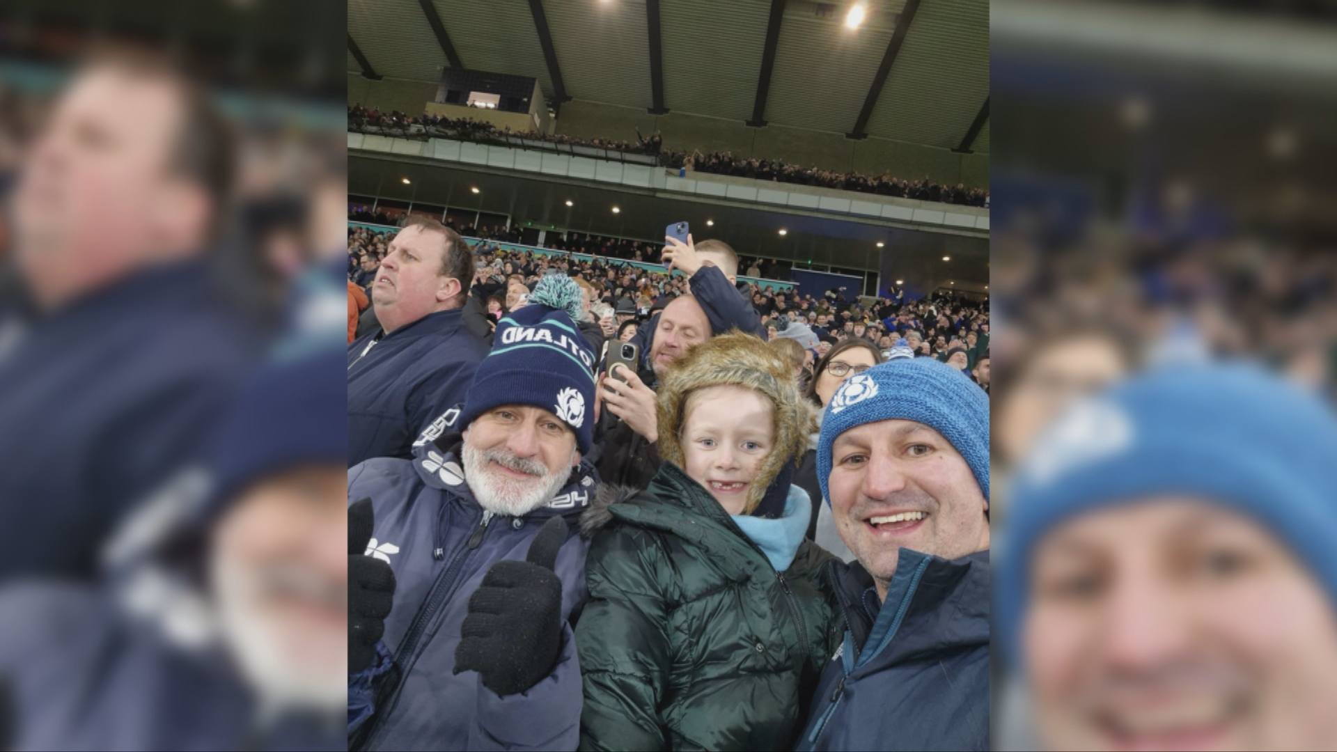 Maisie with her dad and granddad at the game