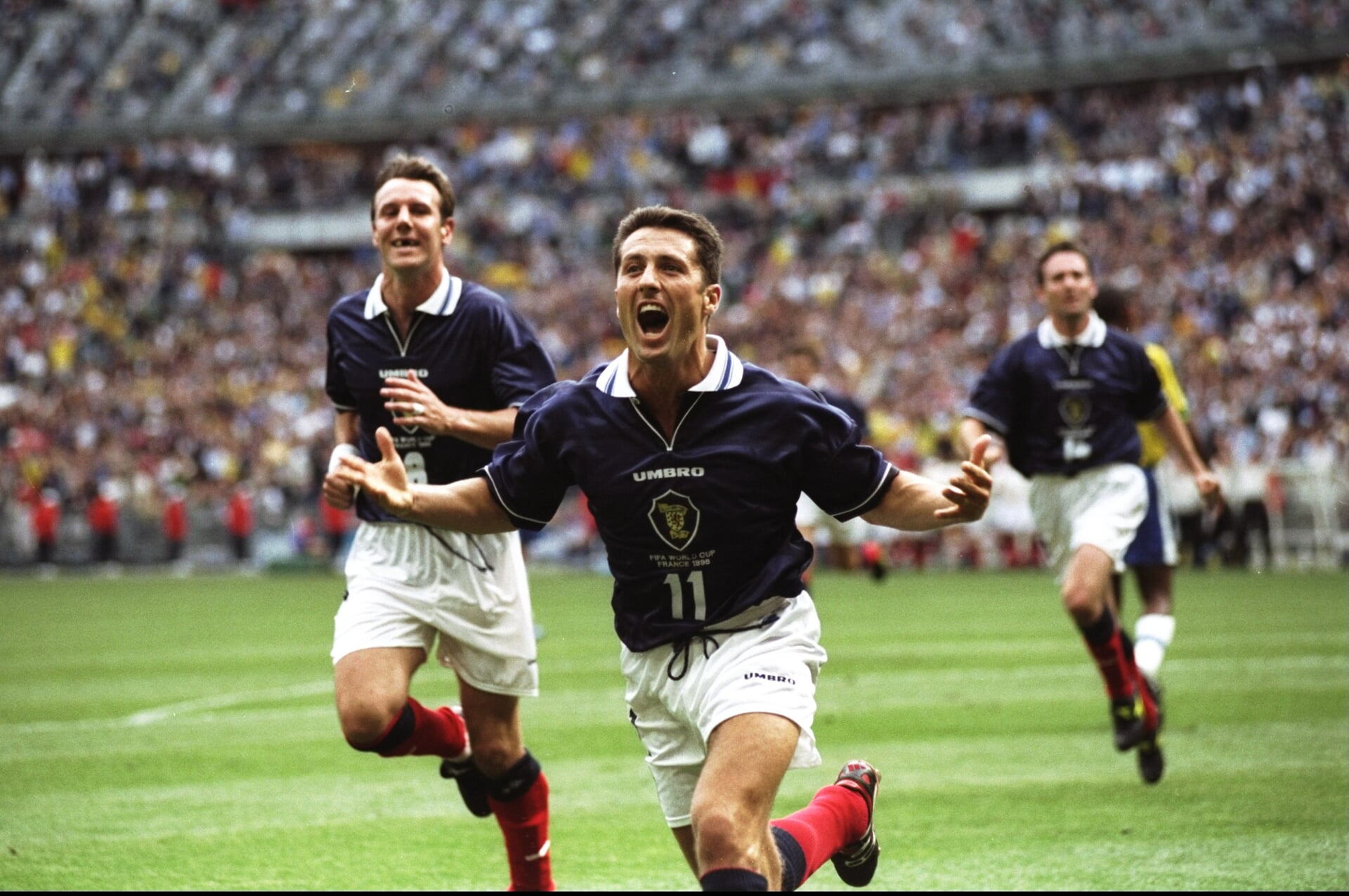 John Collins celebrating after equalising against Brazil from the penalty spot. Mandatory Credit: Clive Brunskill /Allsport