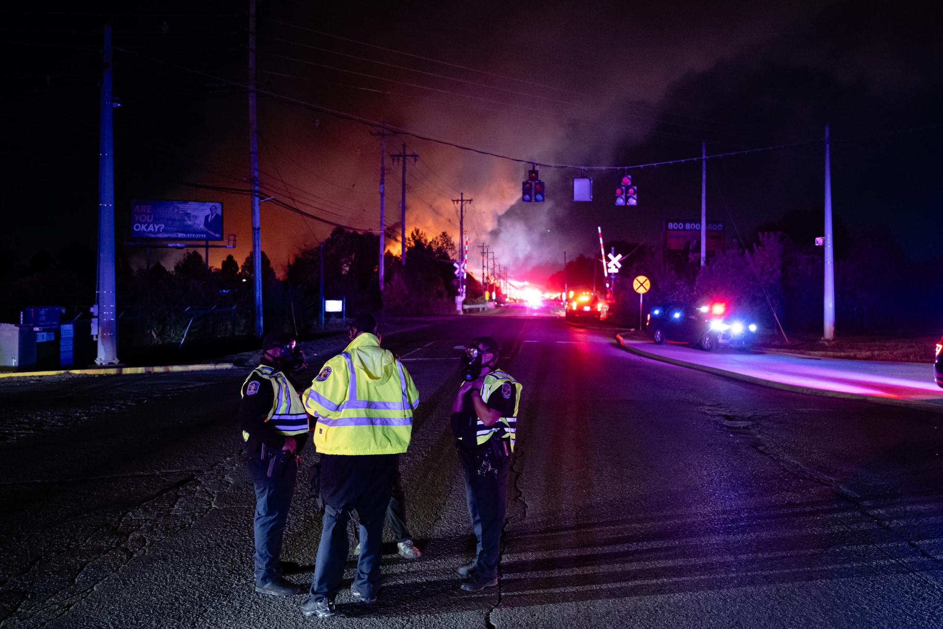 Members of law enforcement wear respirators near the area of the plane crash at Louisville Muhammad Ali International Airport.