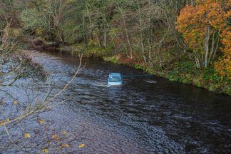 Search for driver who fled after car plunged into River Nairn