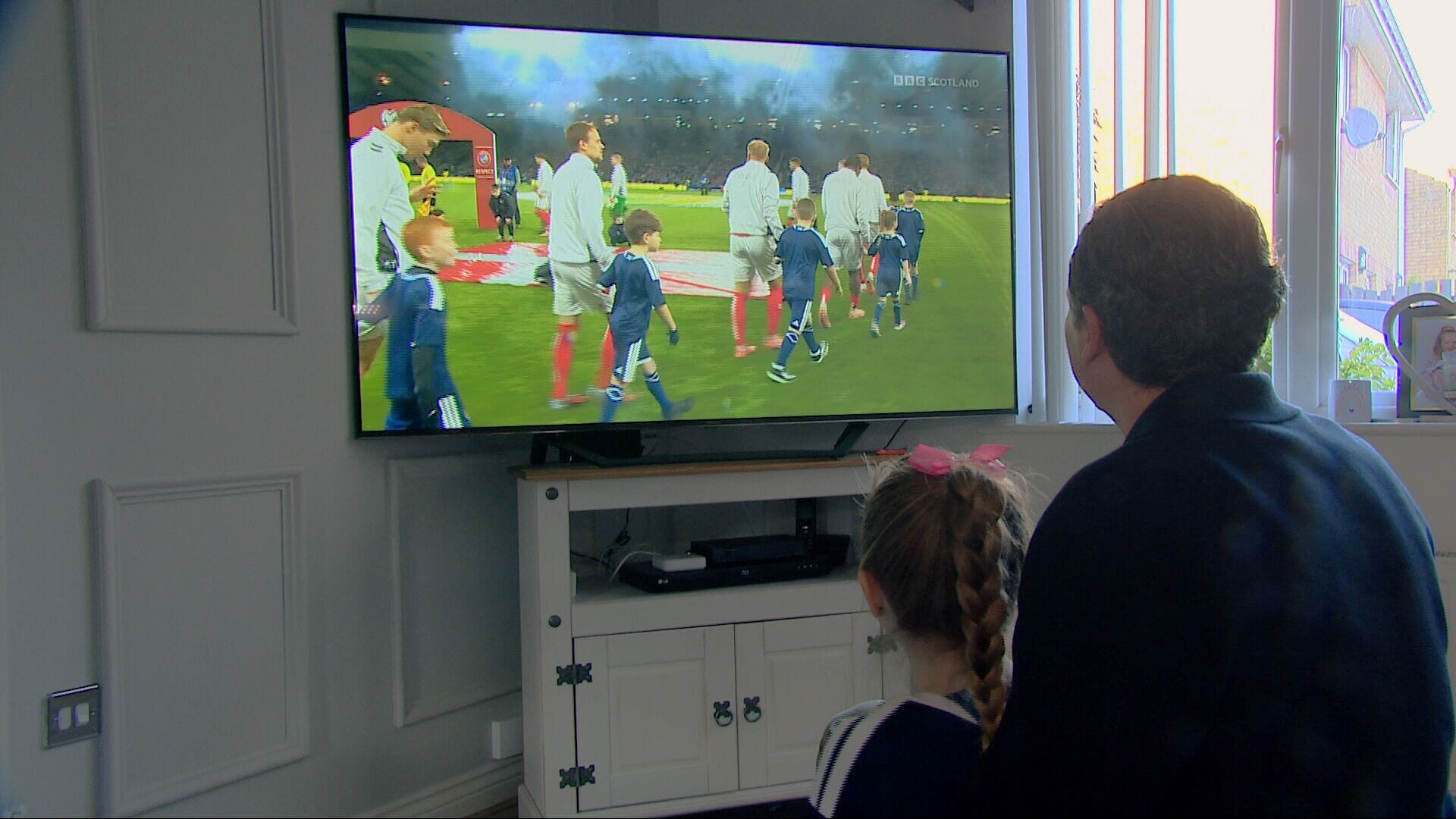 Maisie and her dad watching her big moment together on TV