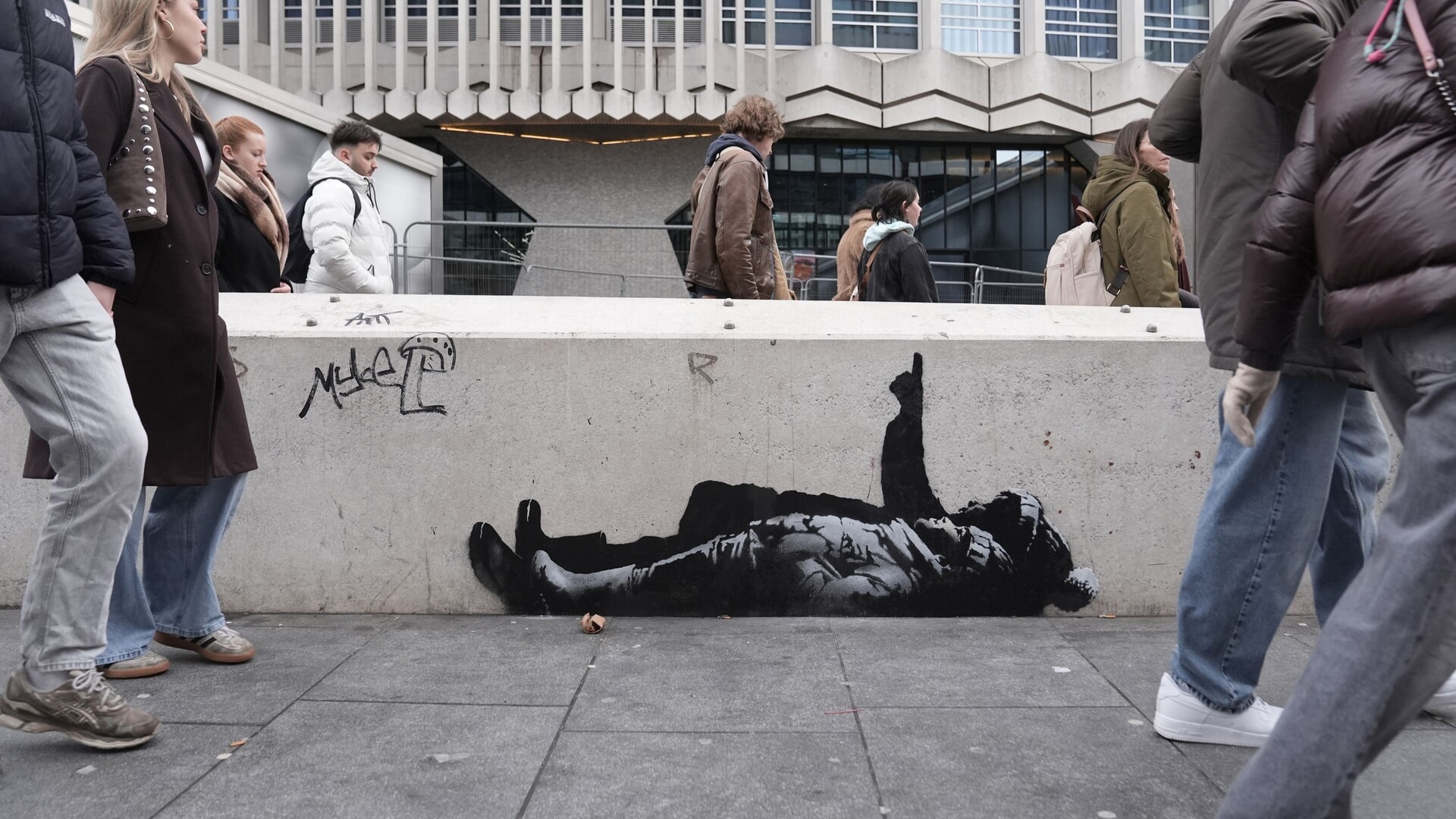 People walking past the artwork outside Centre Point building.