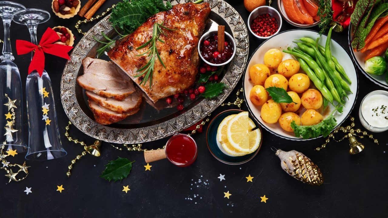 Traditional Christmas dinner on dark background. Holiday food. Top view, copy space