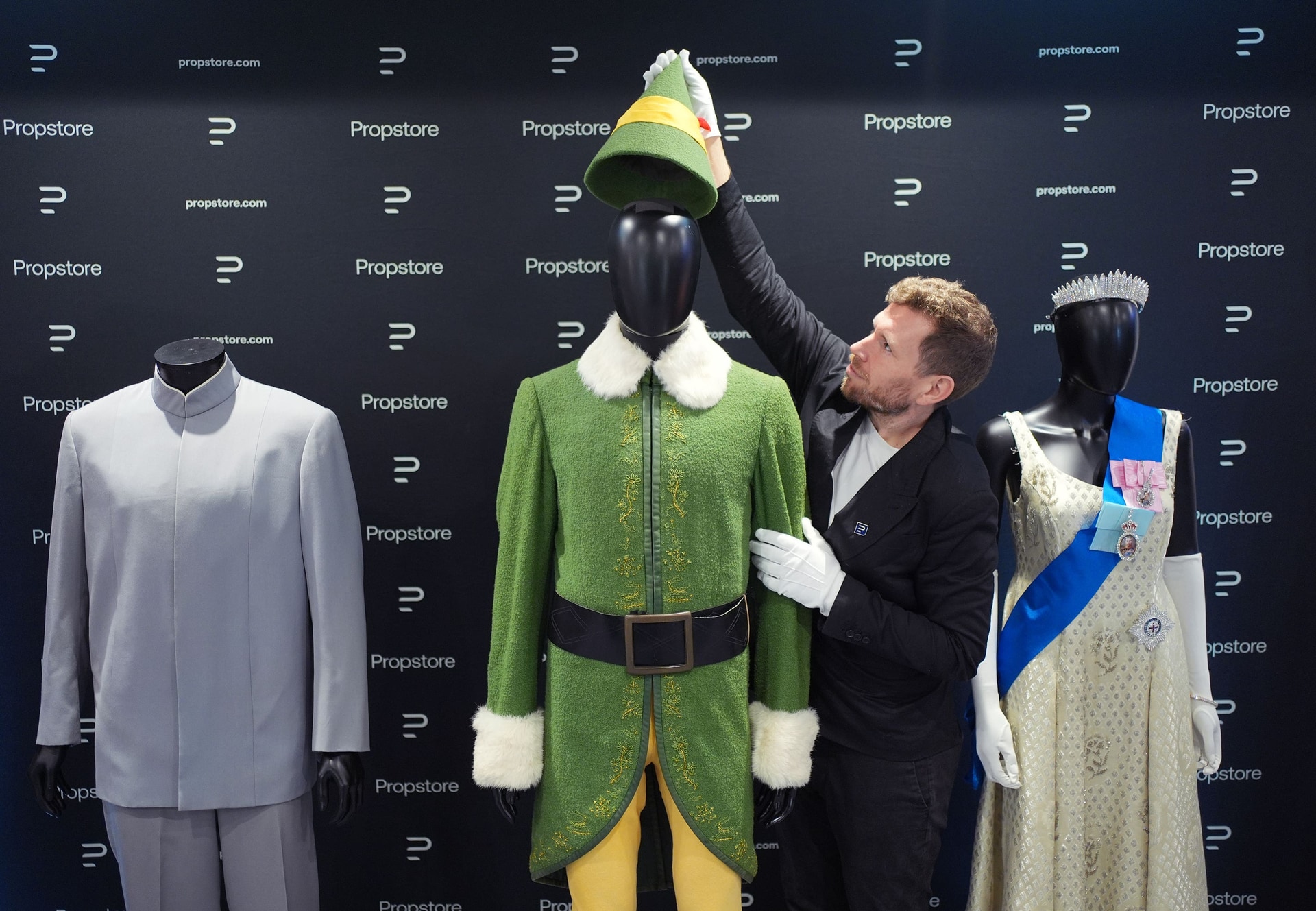 A Propstore employee adjusts the Elf costume that went under the hammer (Yui Mok/PA)