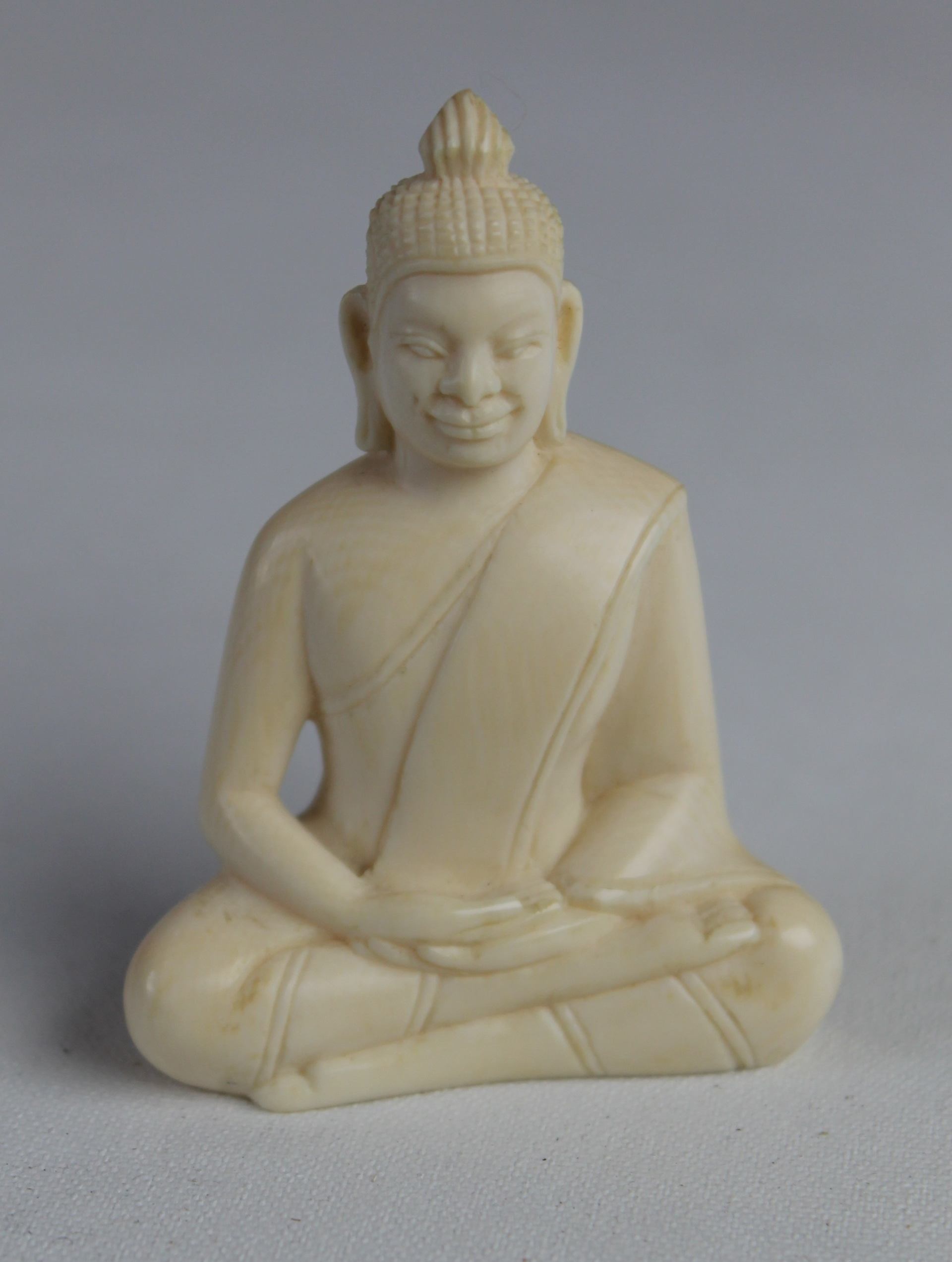 Ivory Buddha on stone base, one of more than 600 artefacts that were stolen from a building housing items from Bristol Museum's British Empire and Commonwealth collection