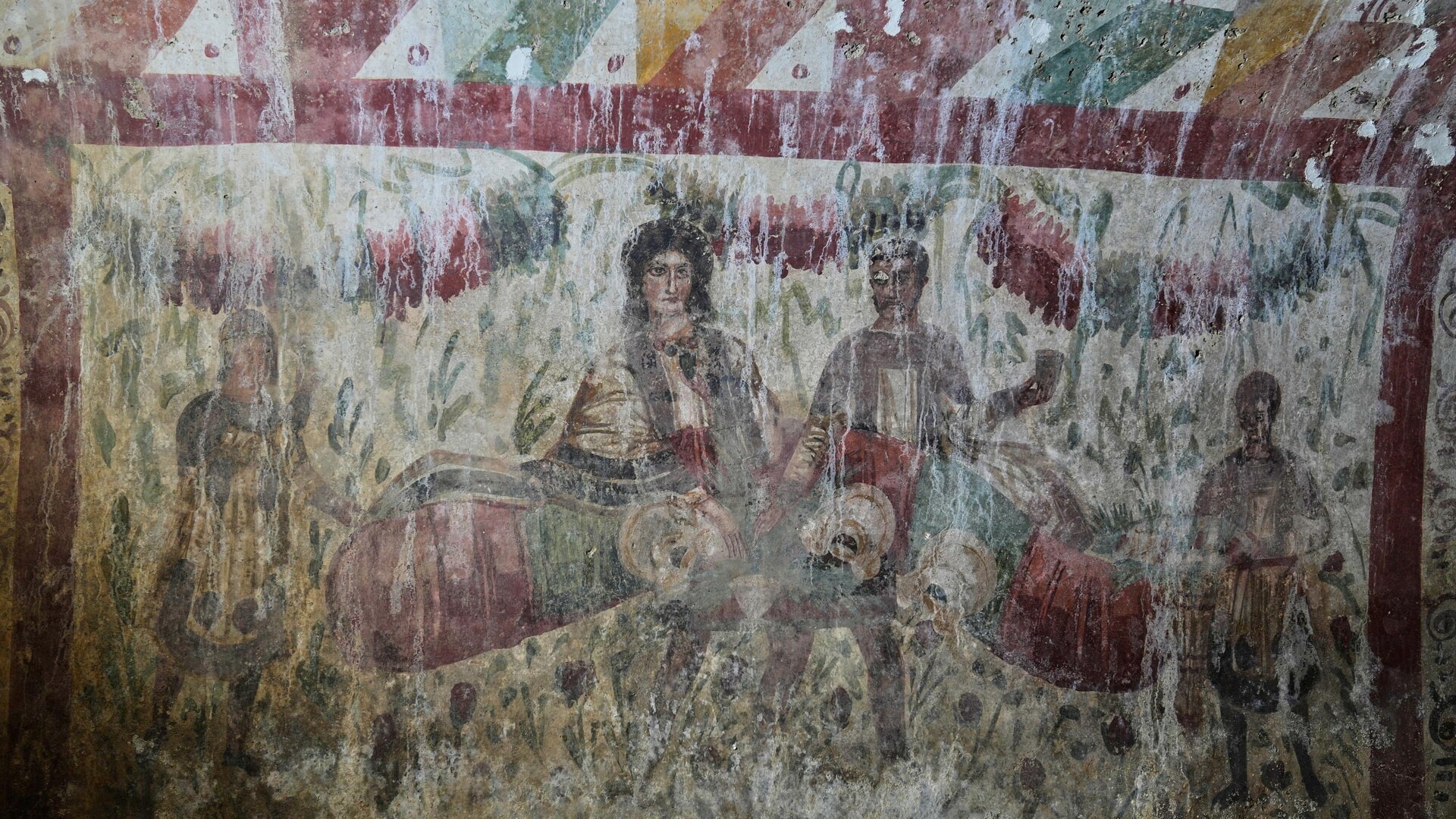 A Roman-era fresco depicting a banquet scene inside the tomb.