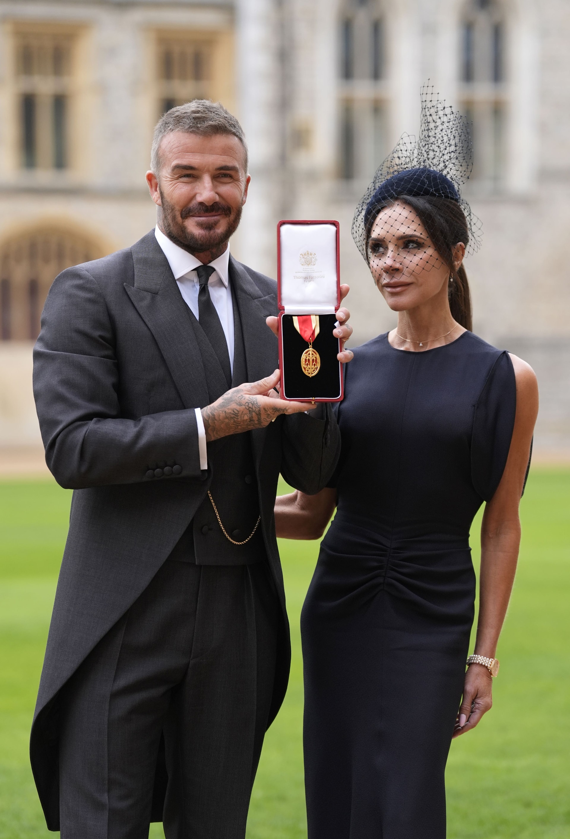 Sir David Beckham, with his wife Lady Beckham after he was made a Knight Bachelor at an investiture ceremony at Windsor Castle, Berkshire.
