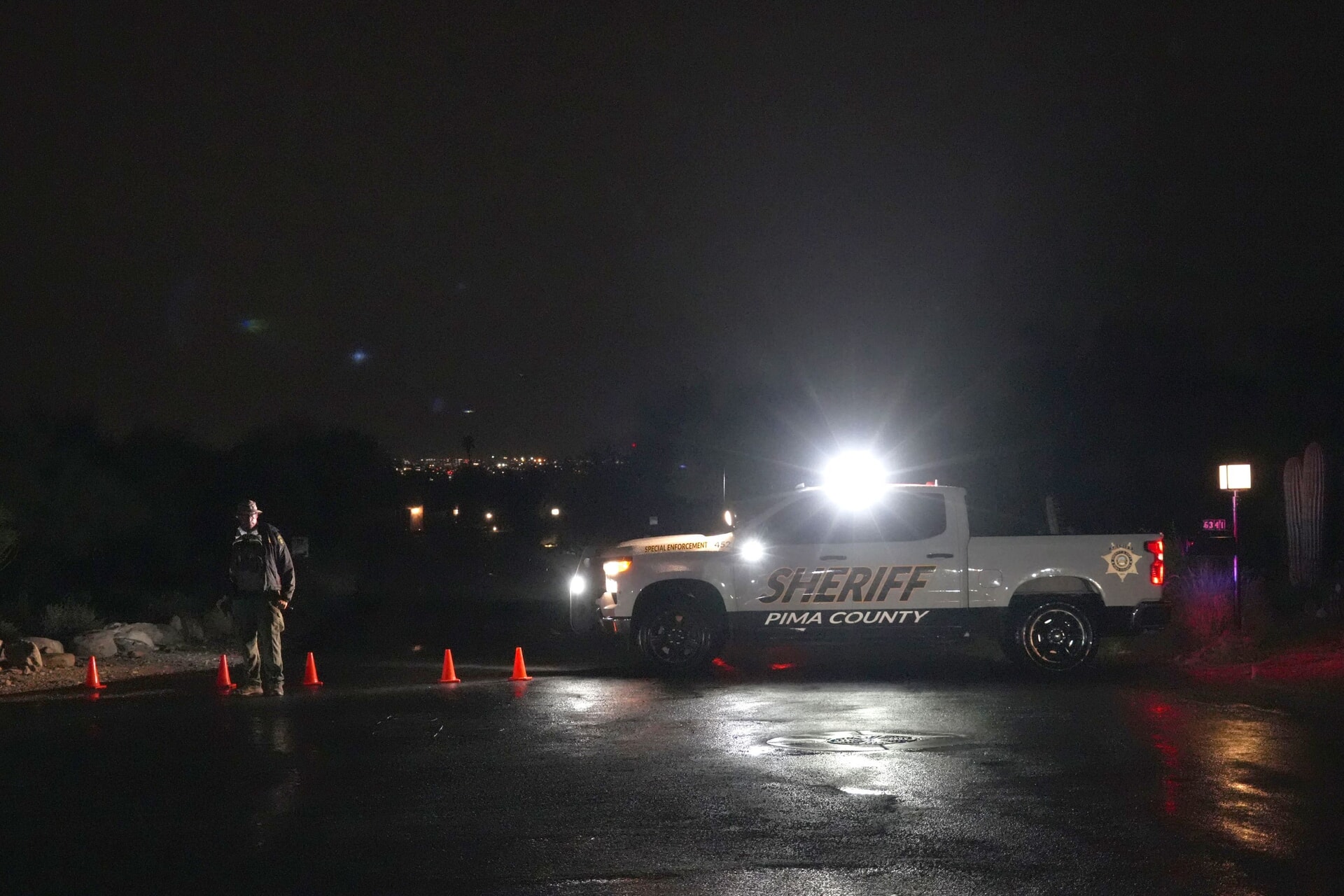 Pima County officials block a road near Nancy Guthrie’s home in Tucson.