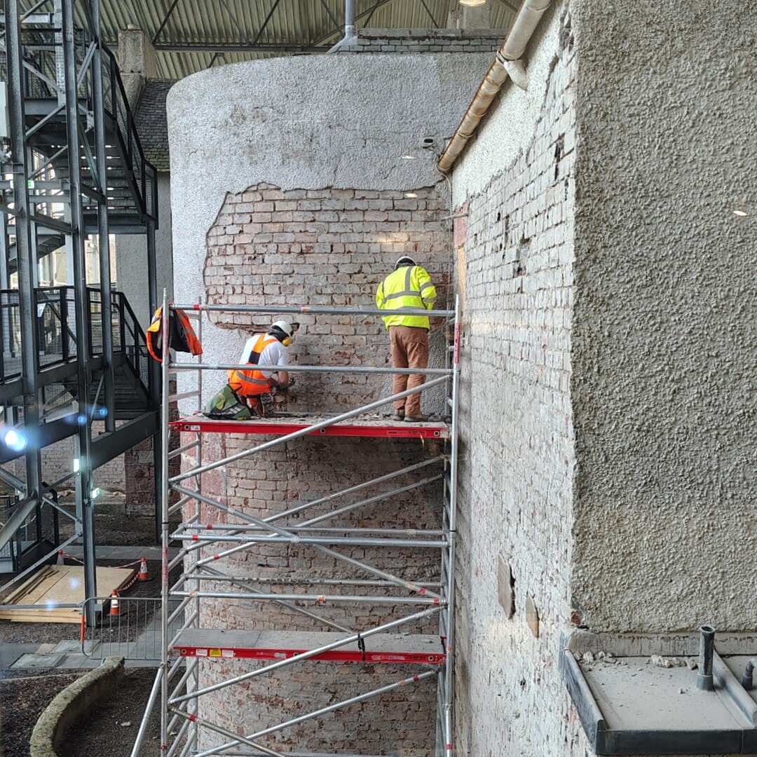 The roughcast is being chipped away to be replaced with a flexible, breathable render