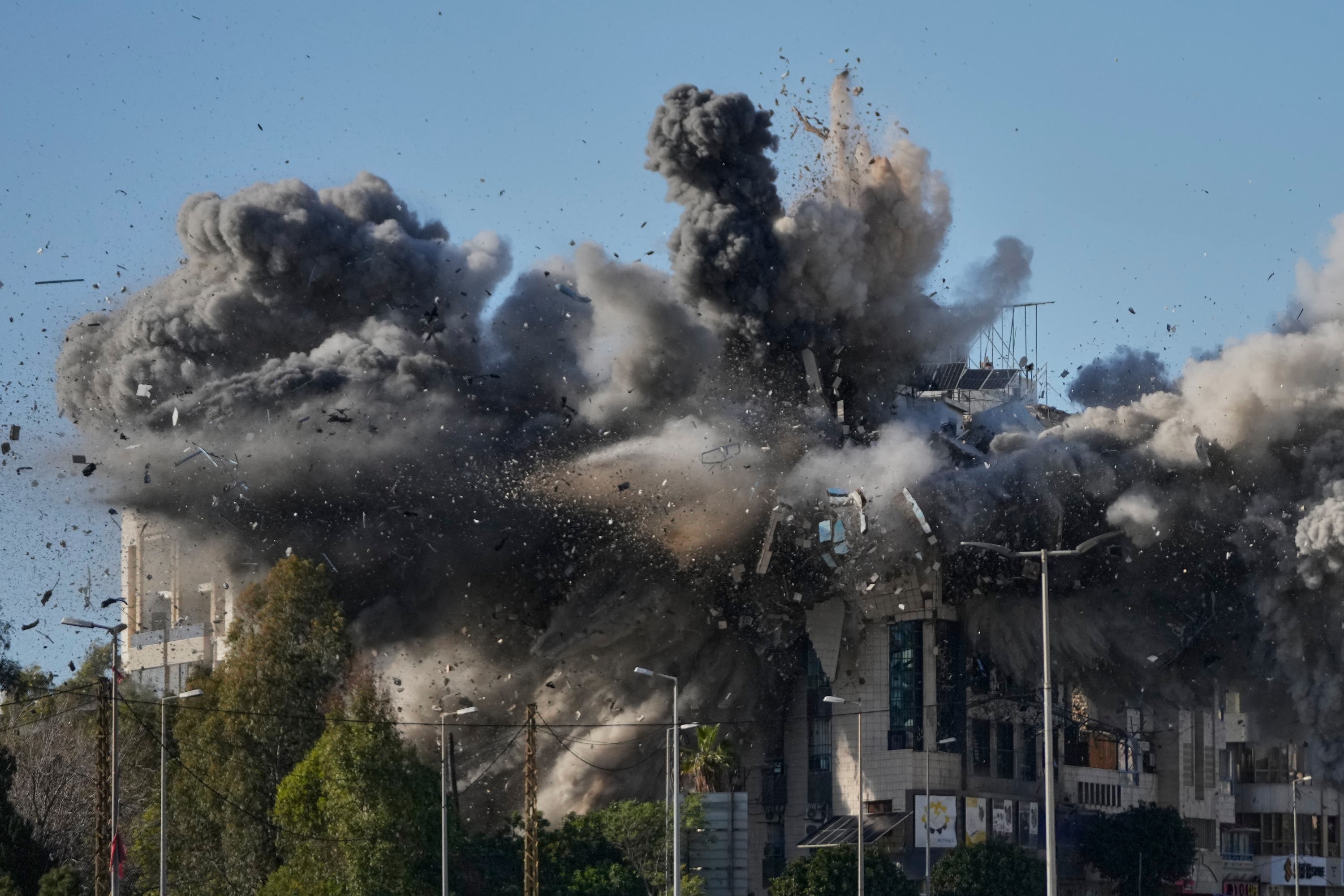 Smoke rises after an Israeli air strike hits a building near the airport road in Beirut, Lebanon