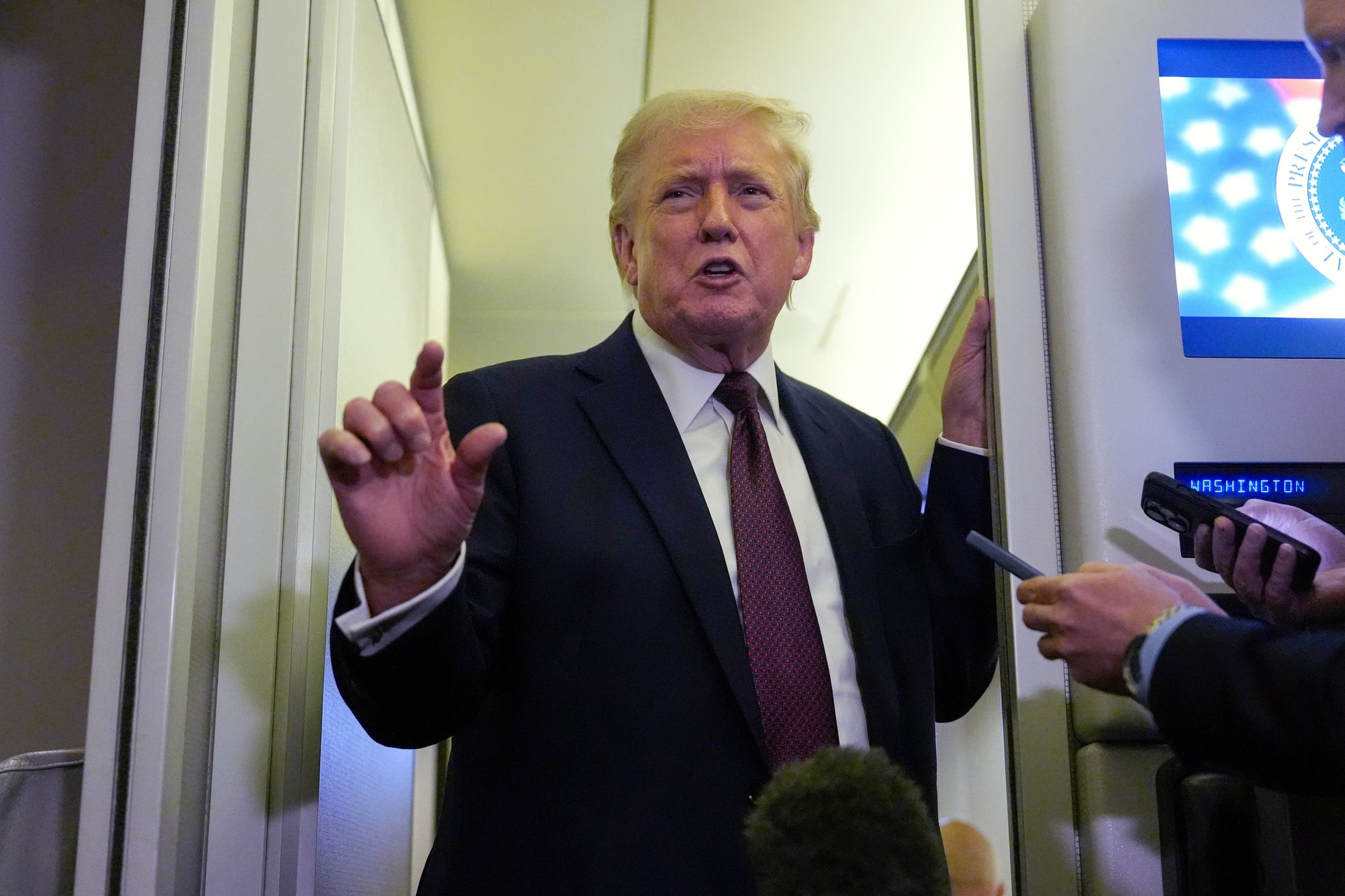 US President Donald Trump speaking to reporters on Air Force One (AP Photo/Mark Schiefelbein)