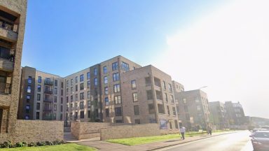 Teenager taken to hospital after falling from Edinburgh flat block window