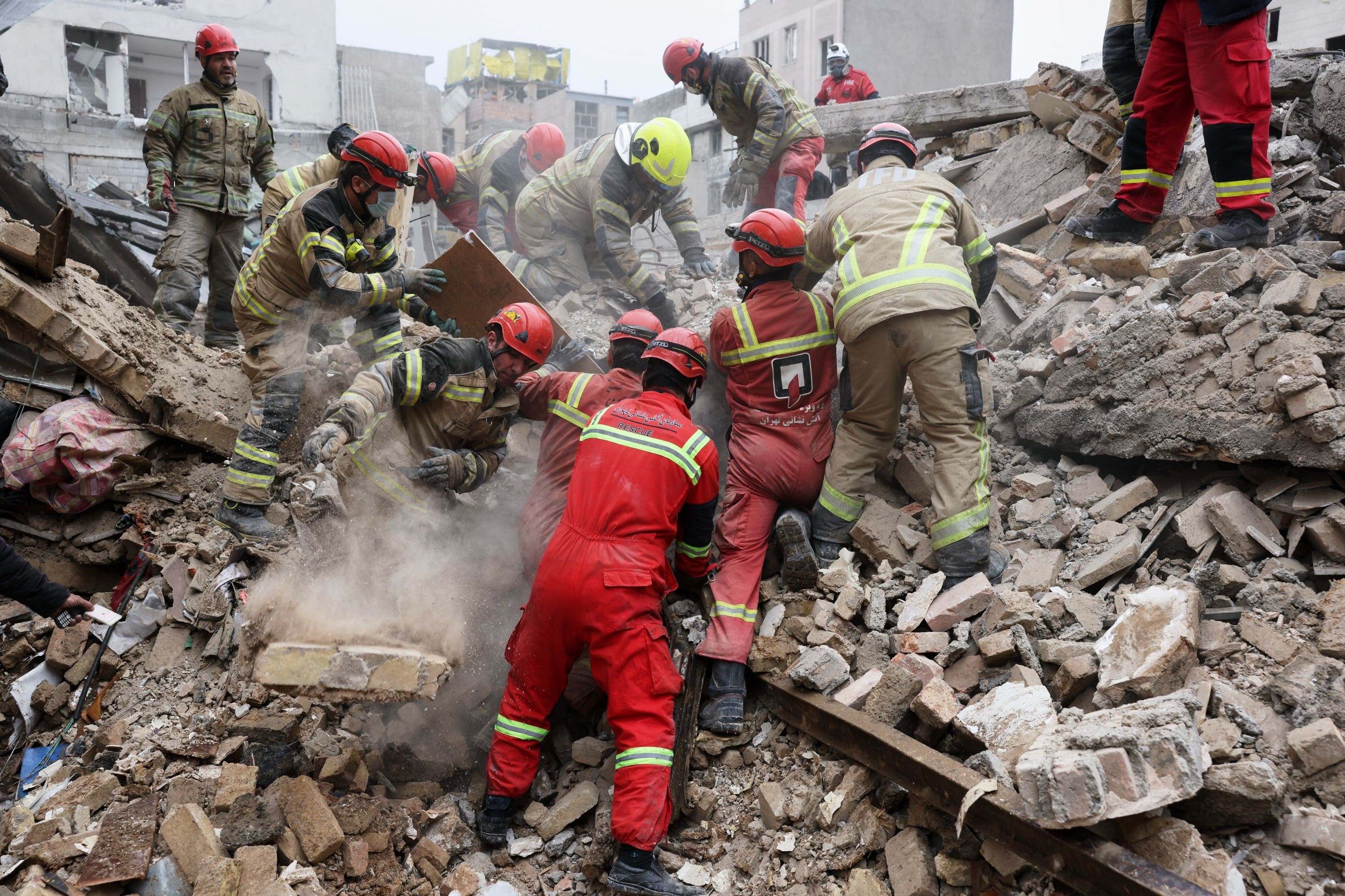 Rescue workers search for survivors after a strike in southern Tehran.