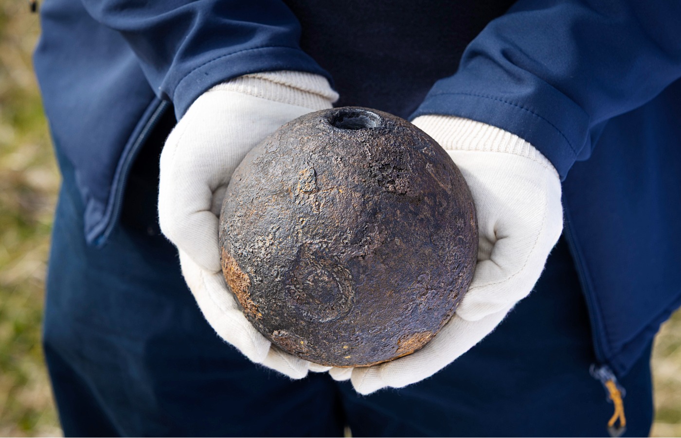 The Coehorn mortar shell, held by National Trust for Scotland's Head of Archaeology, Derek Alexander.