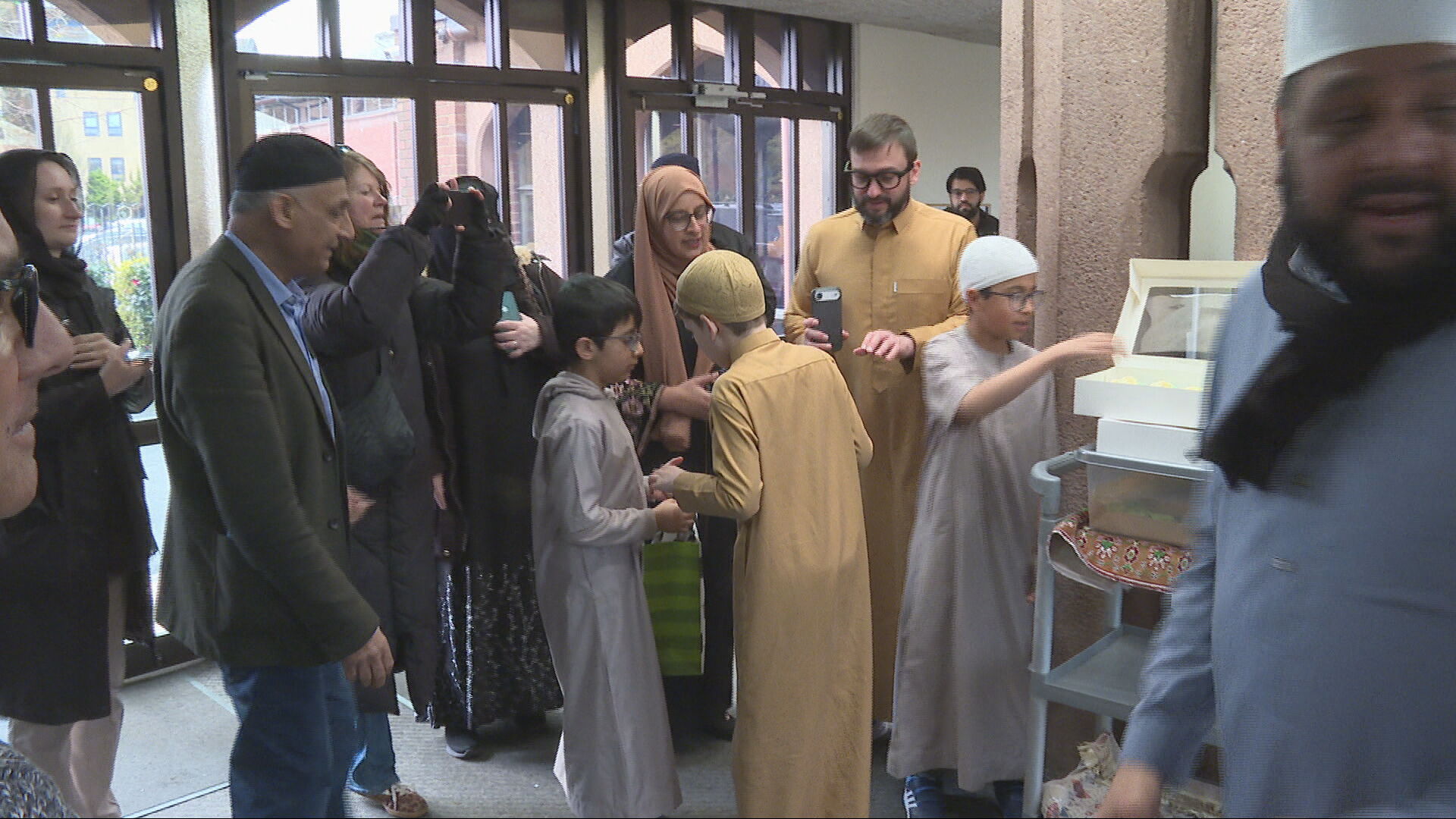 Josh hands out cupcakes to worshippers