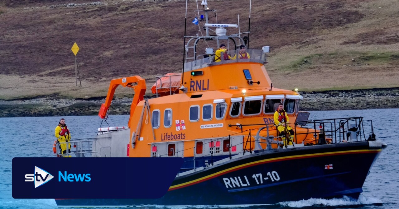 Man and dog rescued by lifeboat after getting stuck at foot of cliffs ...