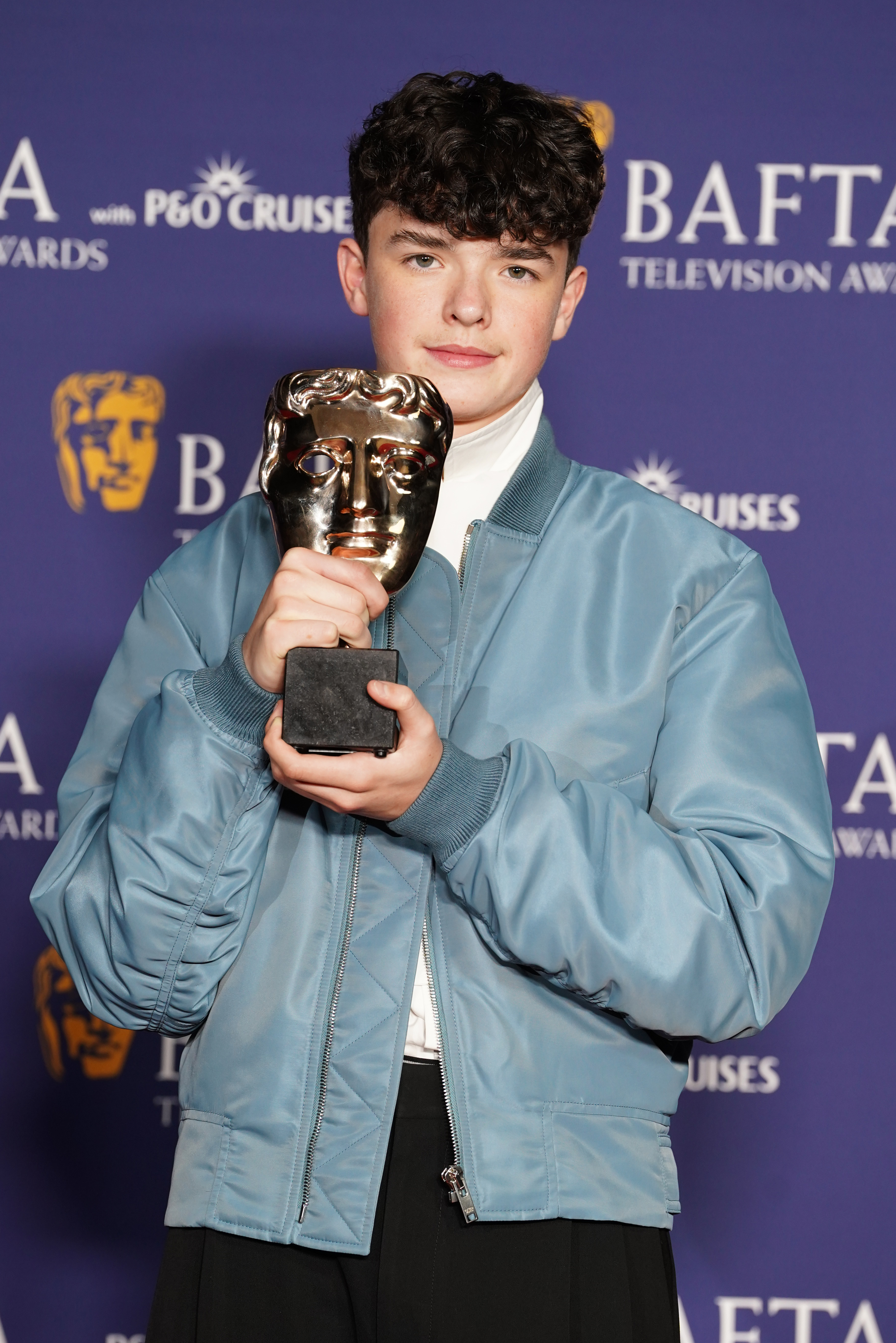 Owen Cooper, winner of the best supporting actor award for Adolescence, in the winners room at the BAFTA TV Awards 2026, at the Royal Festival Hall in London.
